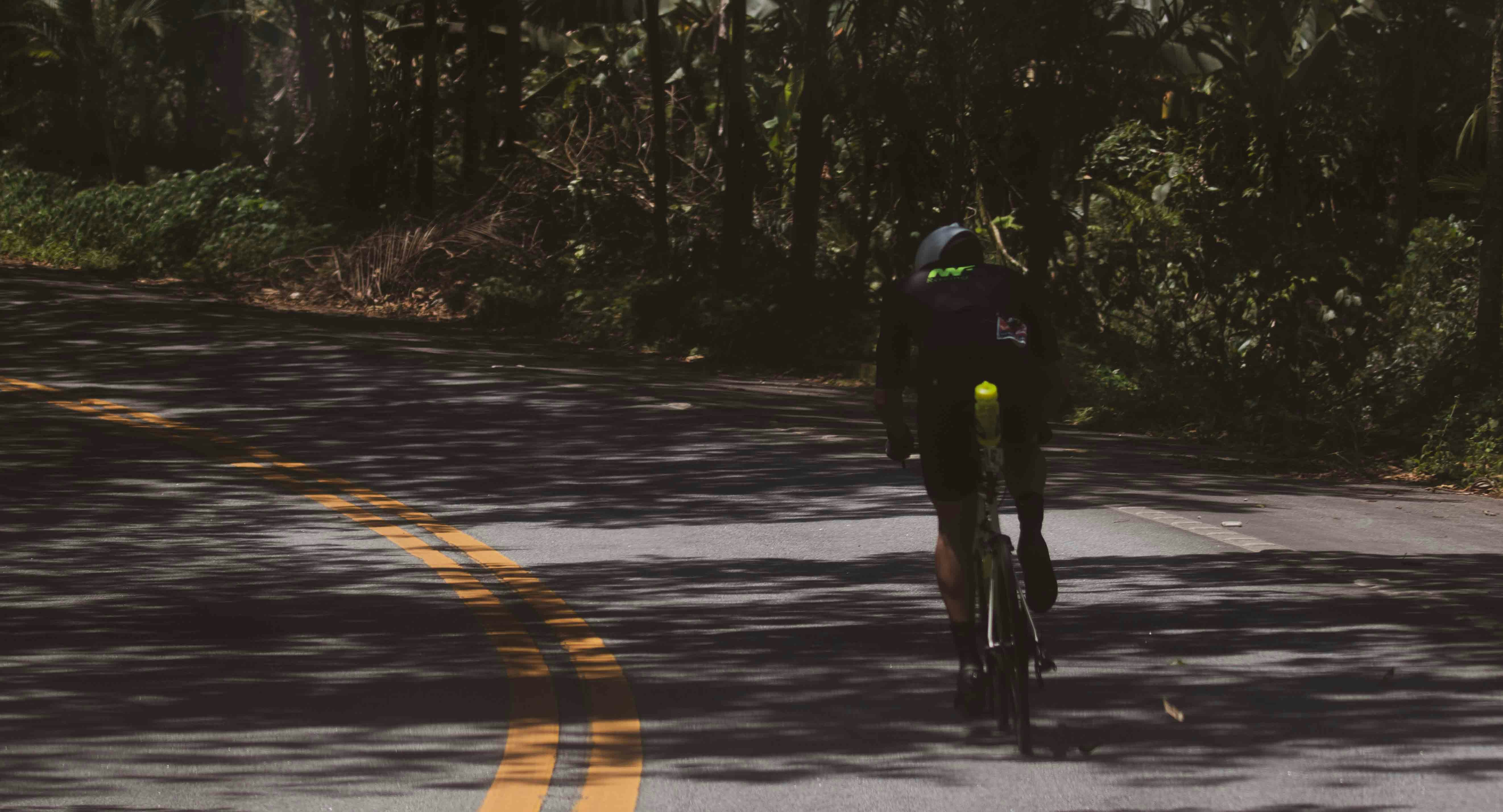 Cyclist riding a road bike outdoors in real conditions.