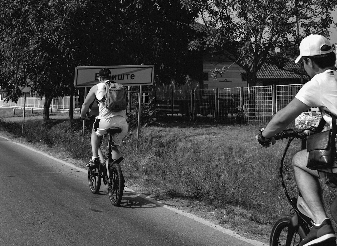 Group of road cyclists riding together outdoors on paved roads.