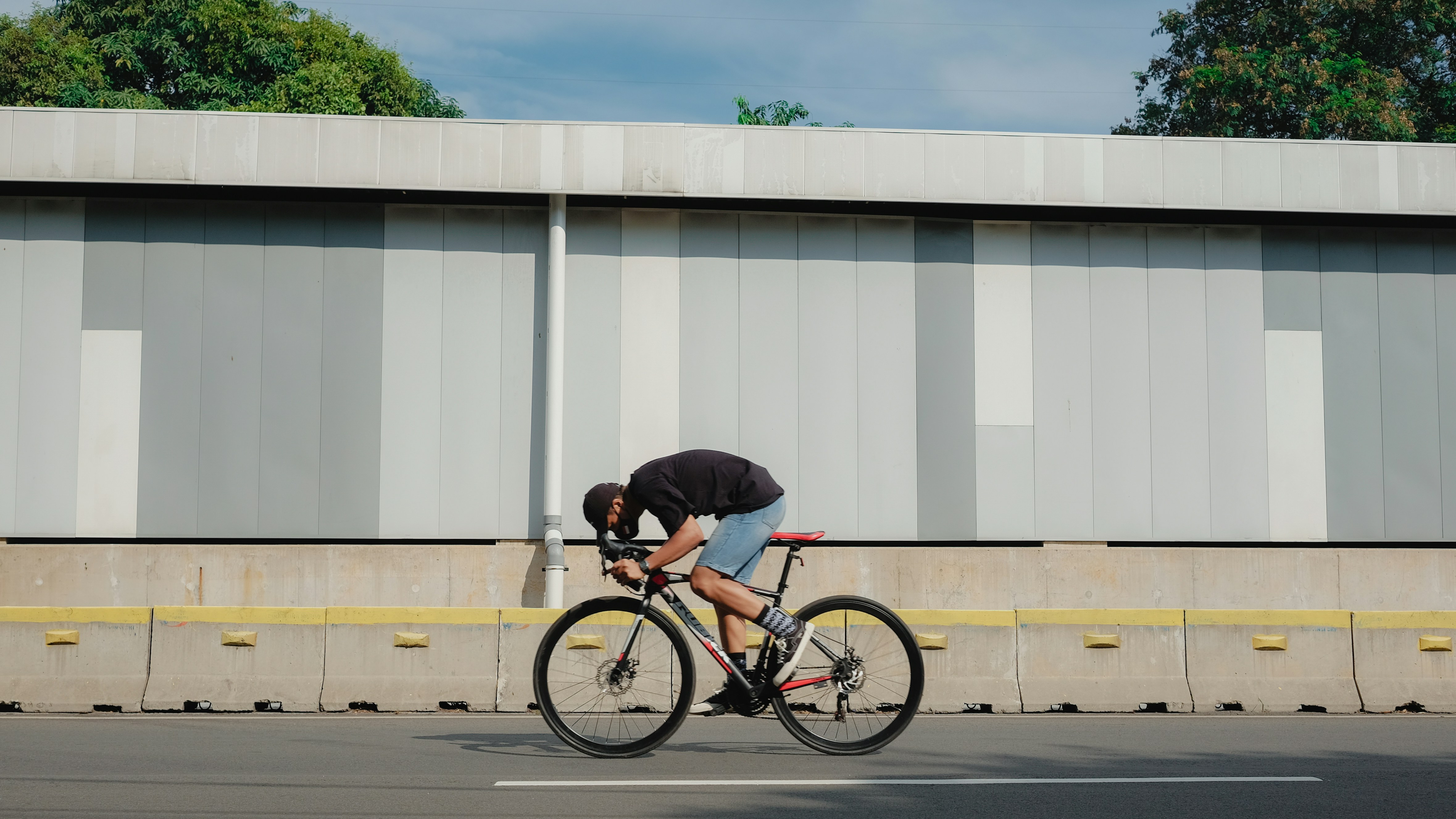 Cyclist riding a road bike outdoors in real conditions.
