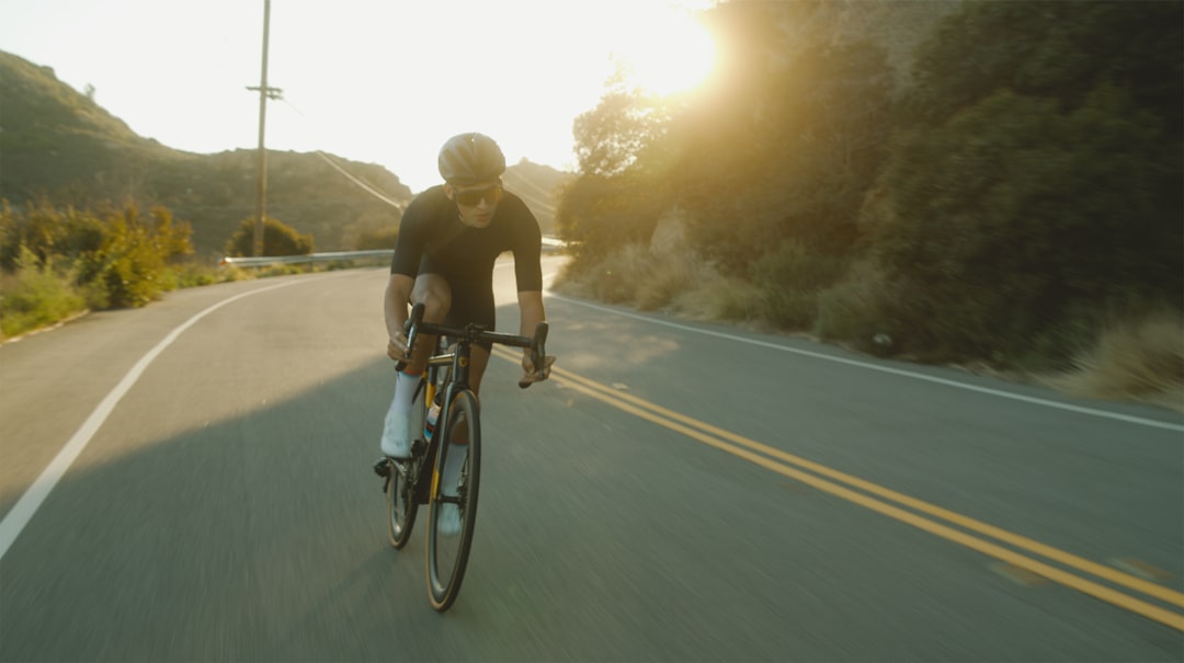 Group of road cyclists riding together outdoors on paved roads.