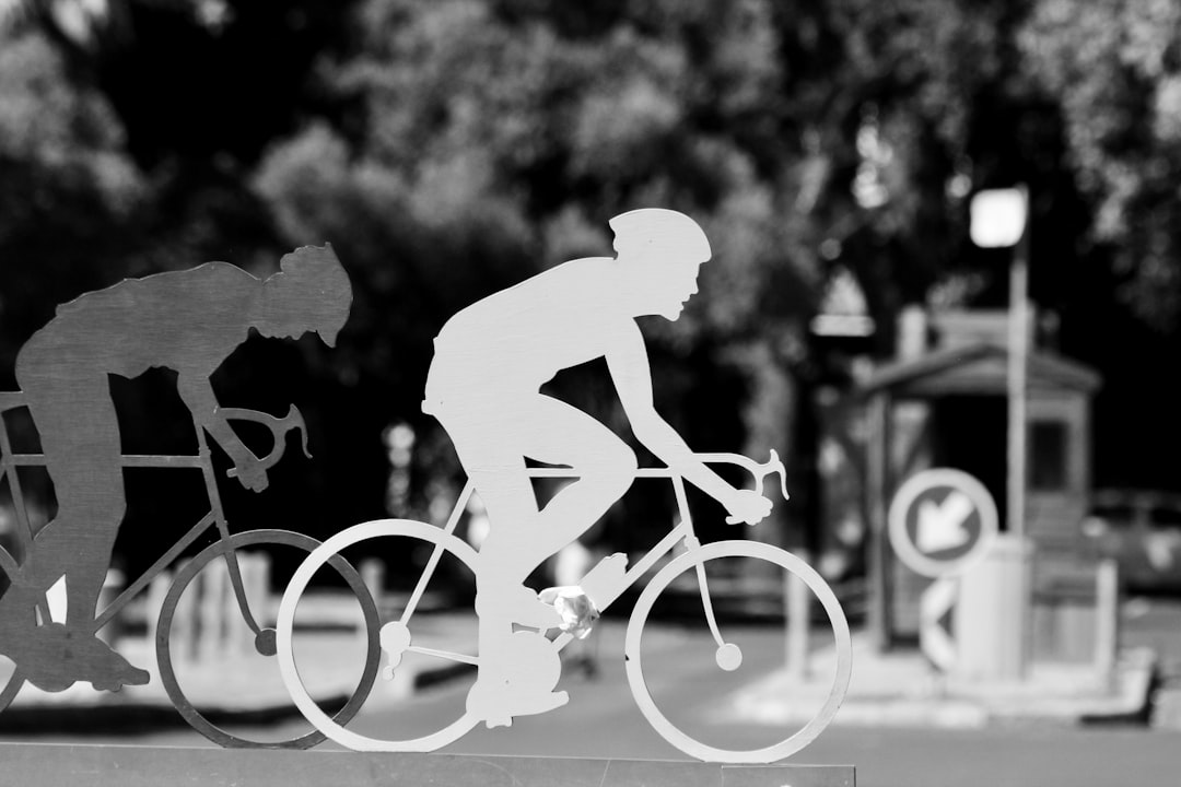 Group of road cyclists riding together outdoors on paved roads.