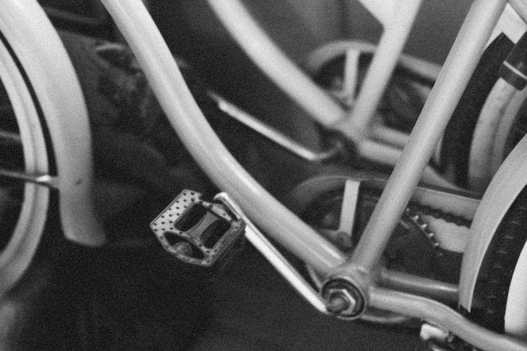 Close-up of a cyclist pedaling on a road bike with a power meter visible.