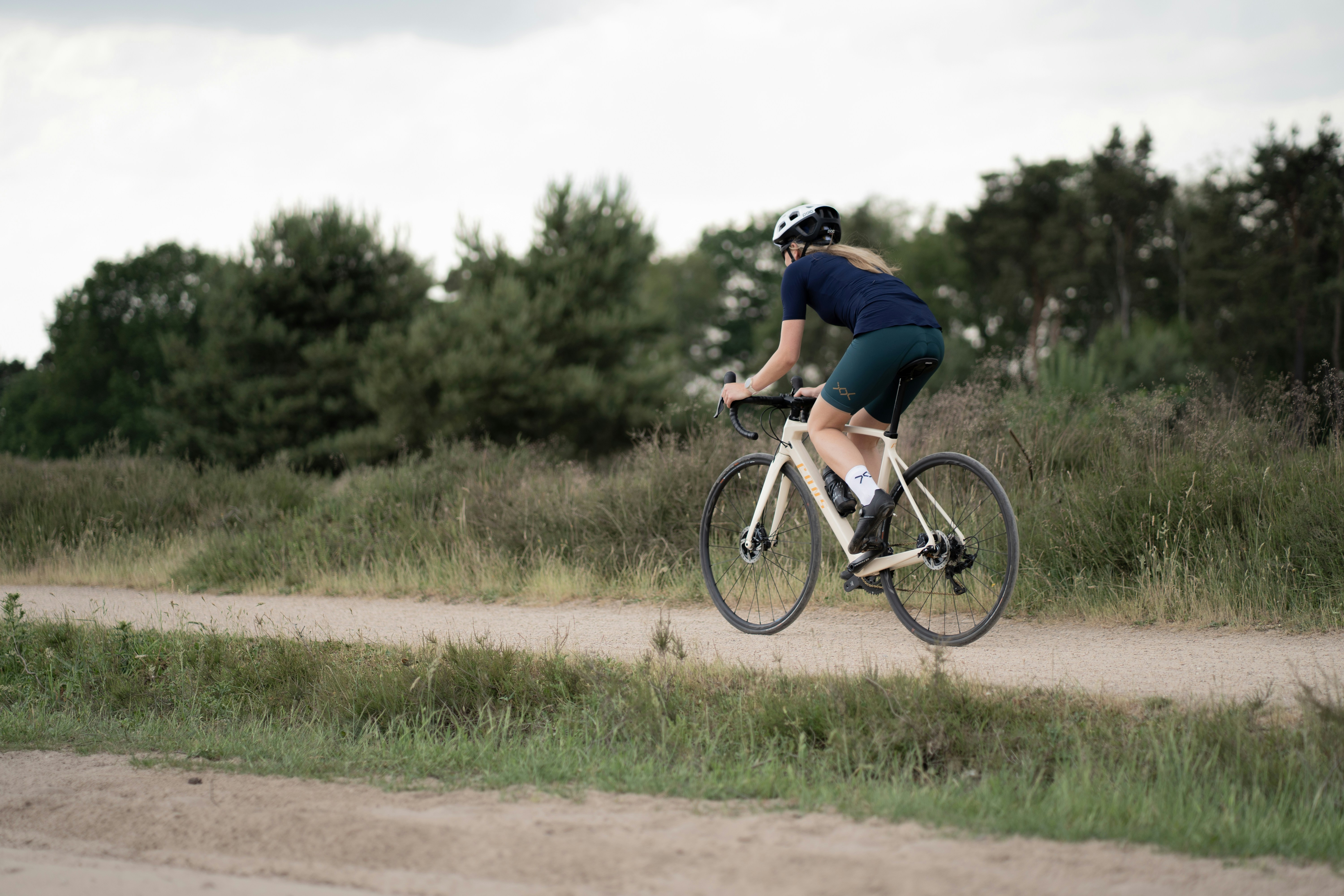 Cyclist riding a road bike outdoors in real conditions.