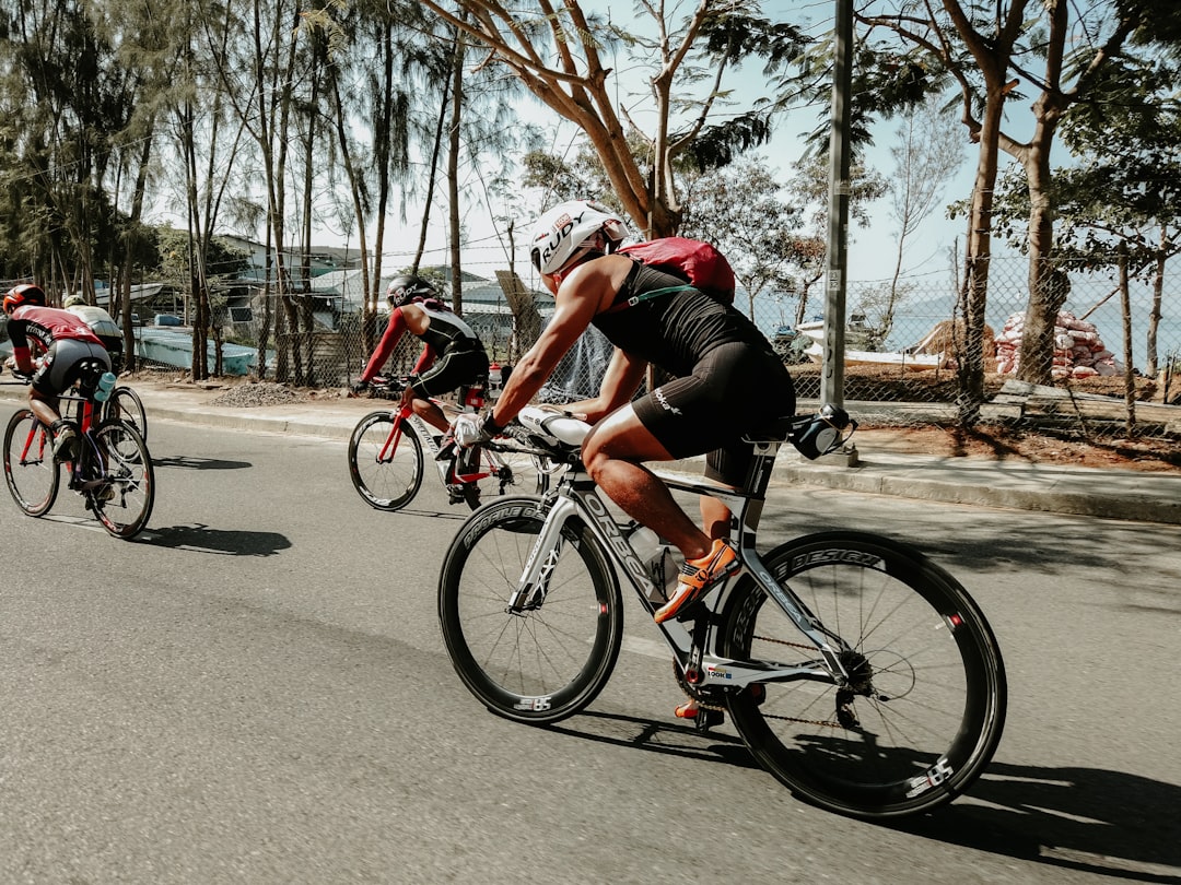 Group of road cyclists riding together outdoors on paved roads.