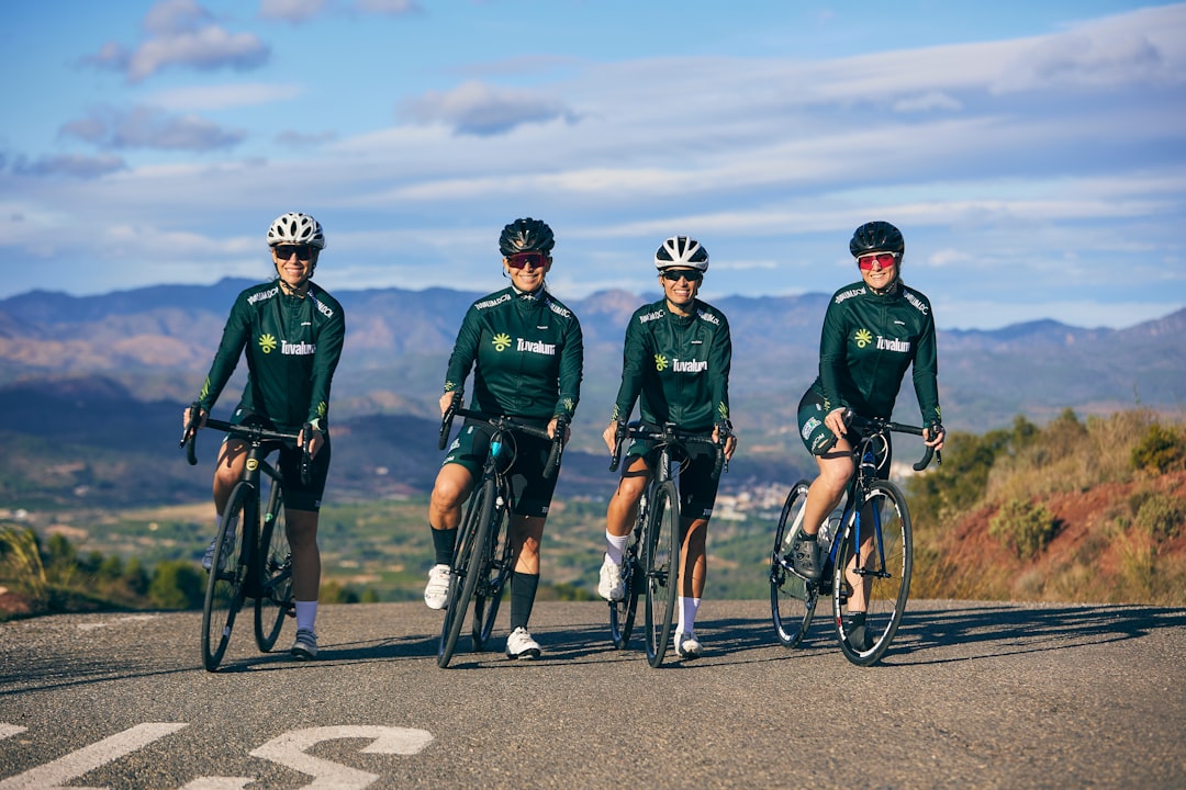 Group of road cyclists riding together outdoors on paved roads.