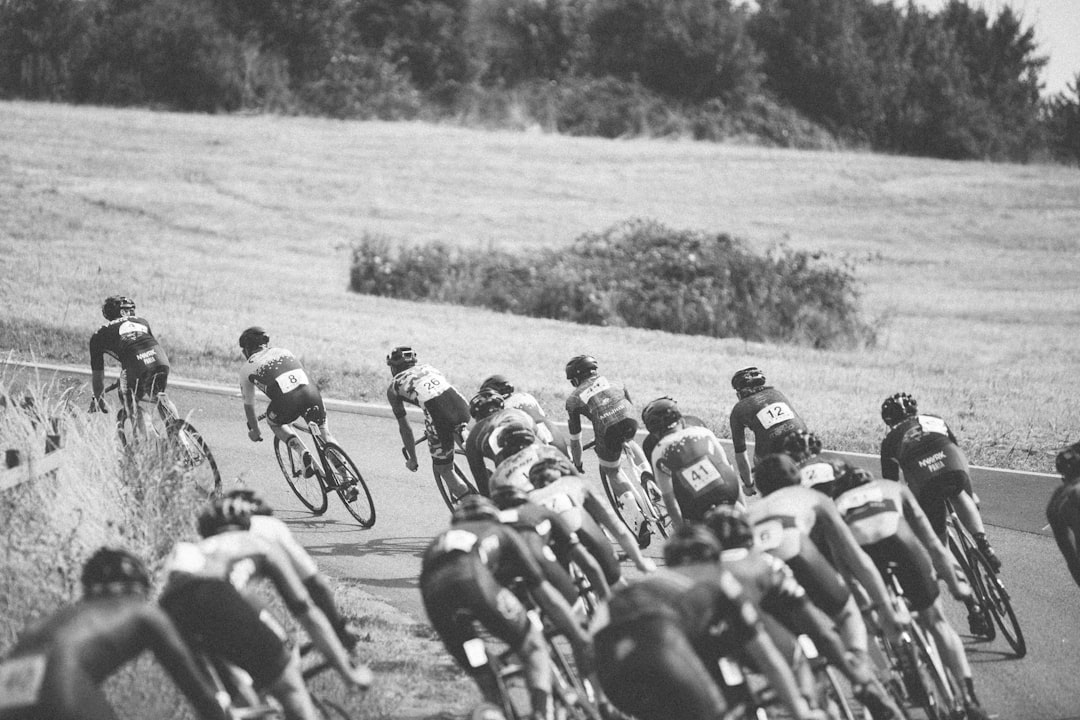 Group of road cyclists riding together outdoors on paved roads.