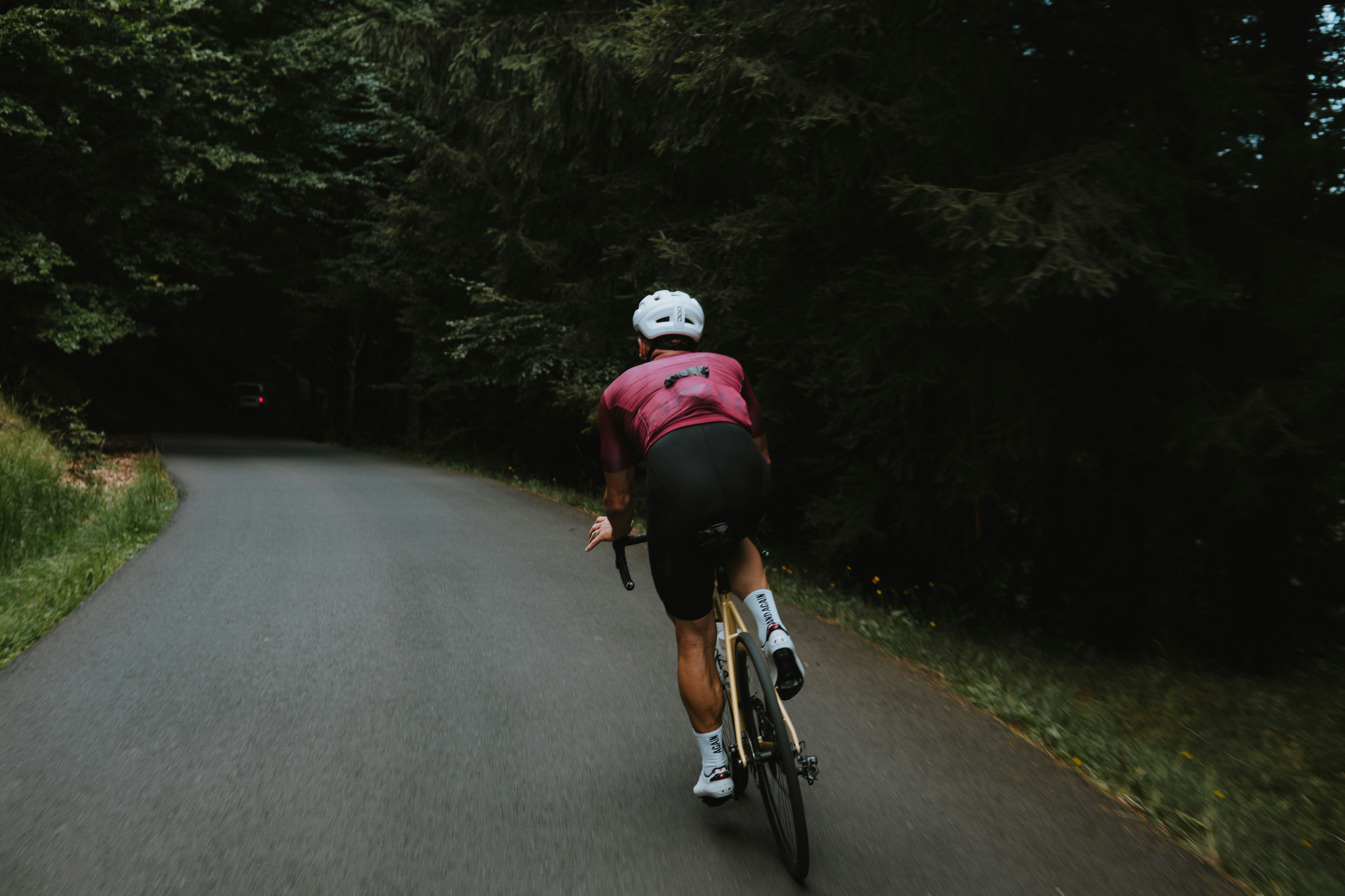 Cyclist riding a road bike outdoors in real conditions.