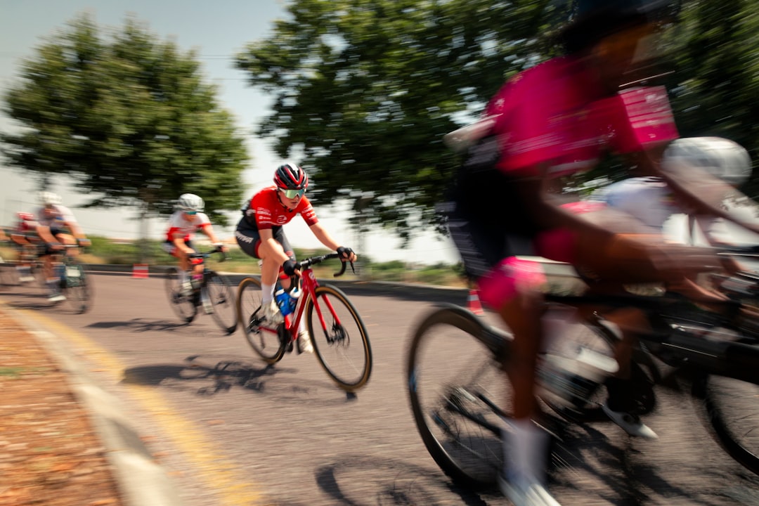 Group of road cyclists riding together outdoors on paved roads.