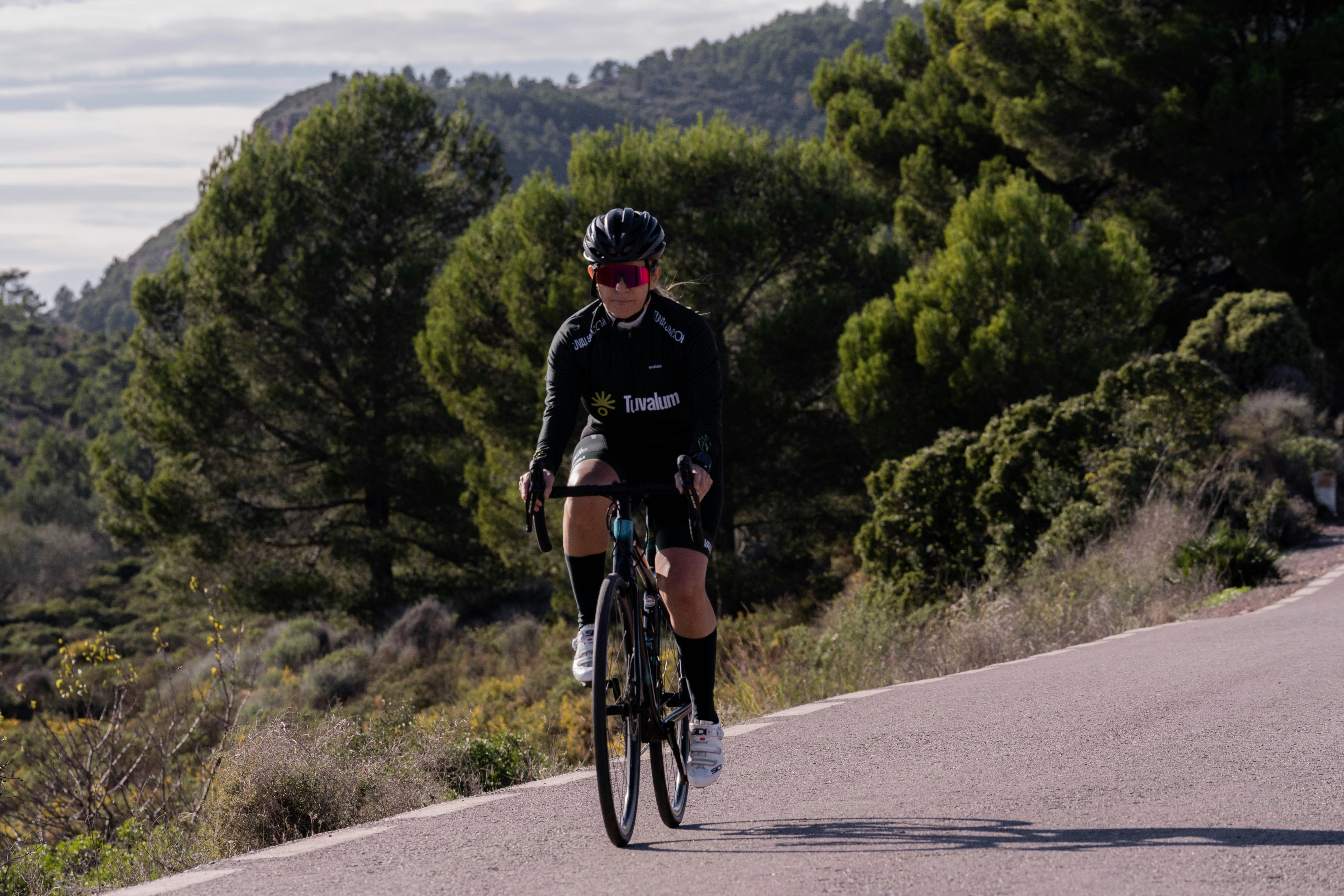 Cyclist riding a road bike outdoors in real conditions.