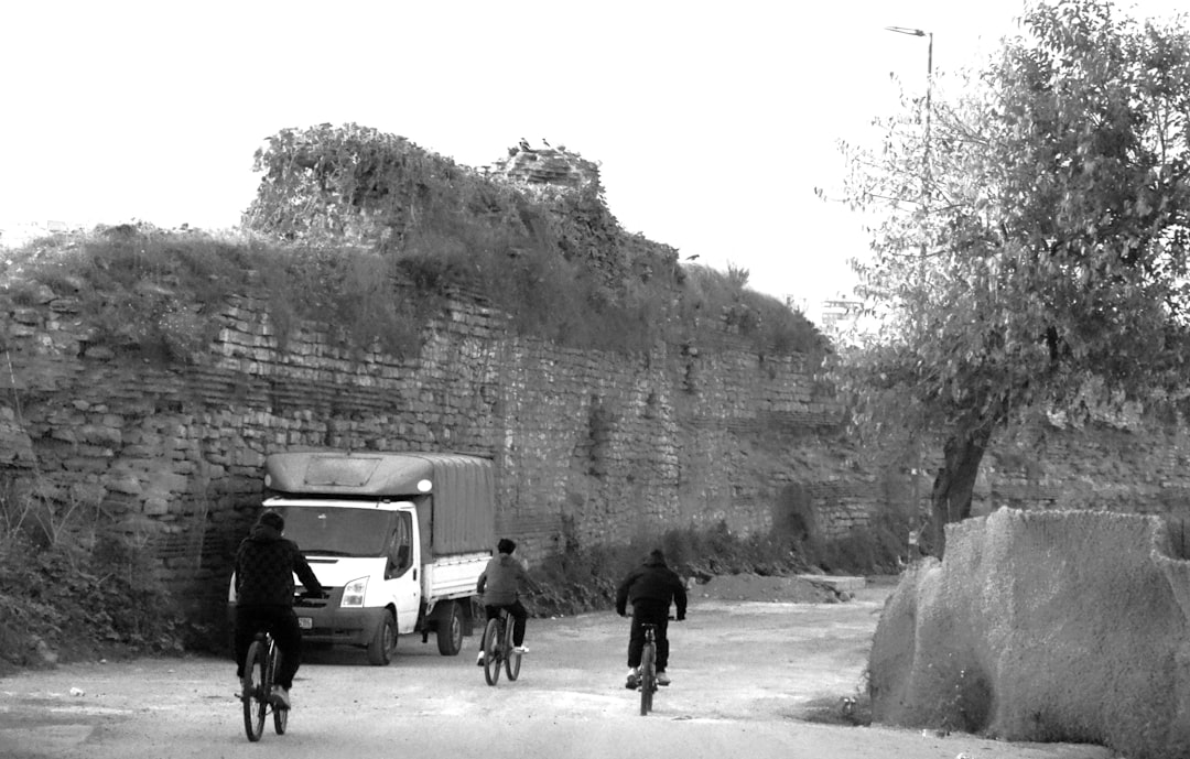 Group of road cyclists riding together outdoors on paved roads.