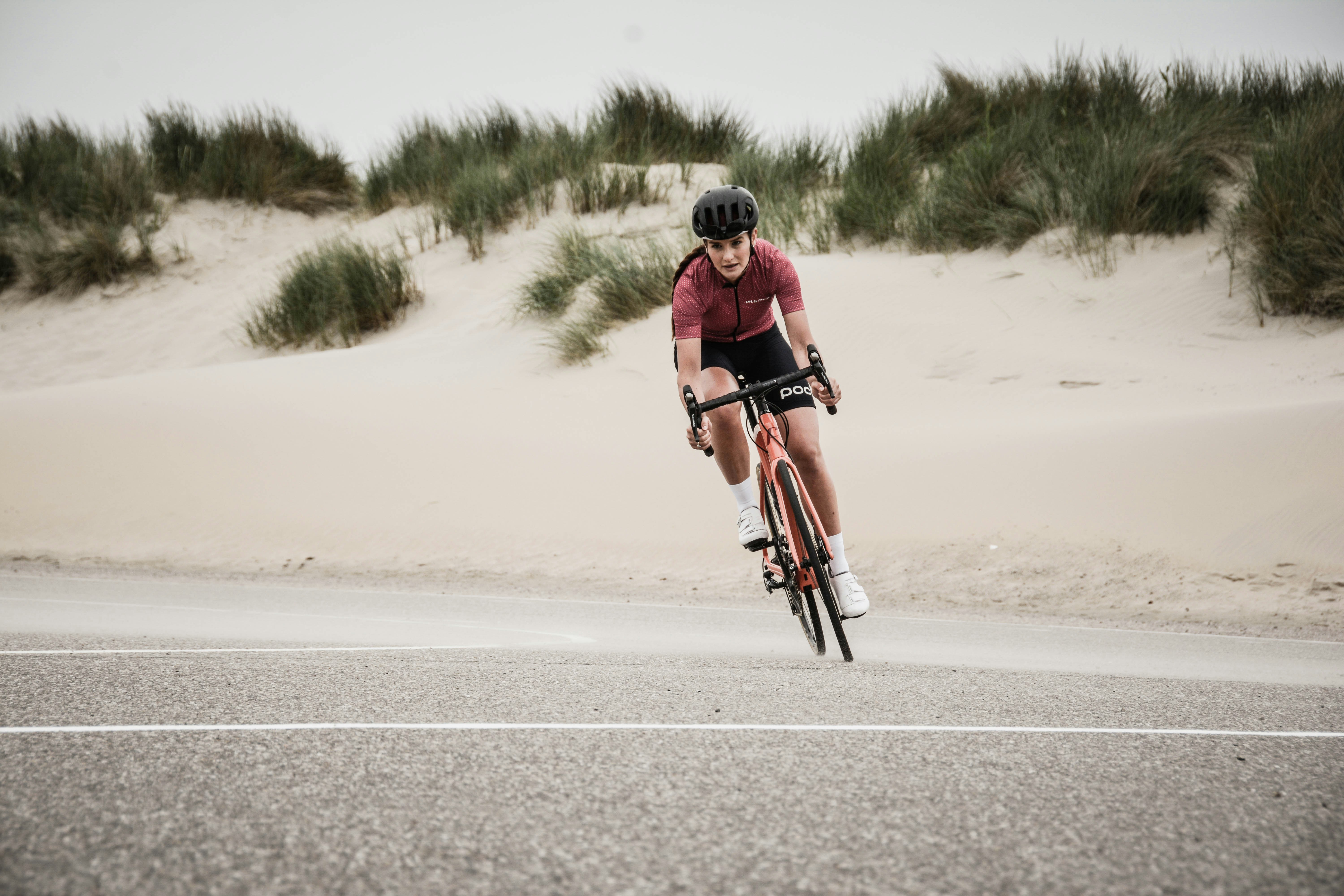 Cyclist riding a road bike outdoors in real conditions.