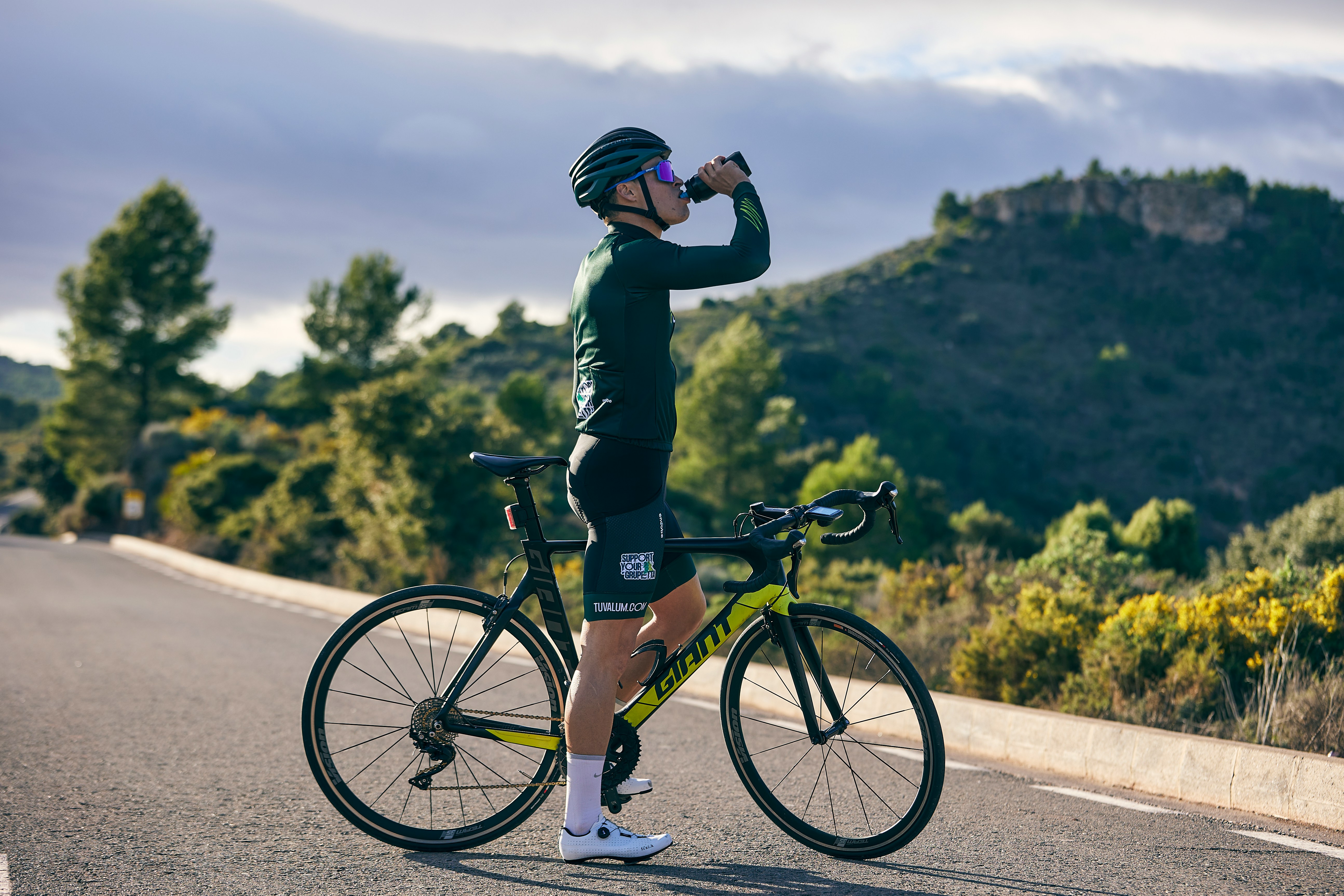 Cyclist riding a road bike outdoors in real conditions.