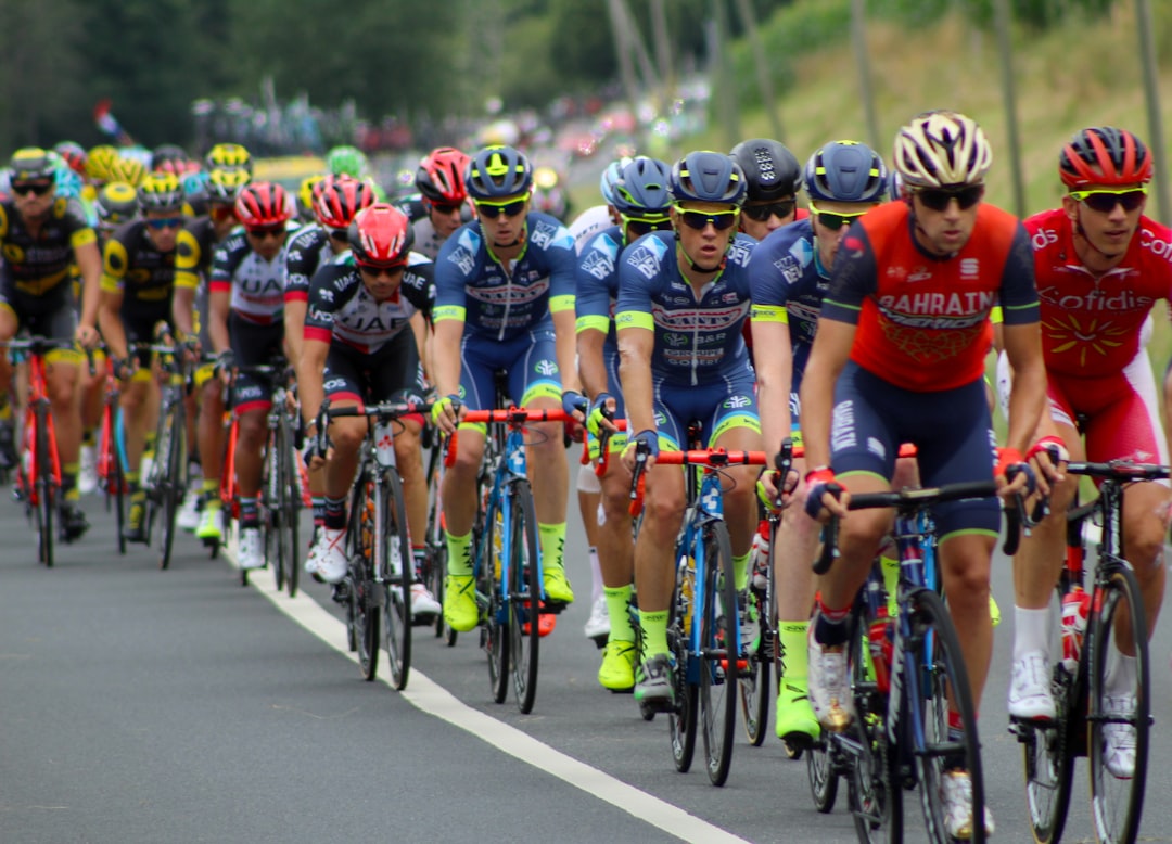 Group of road cyclists riding together outdoors on paved roads.