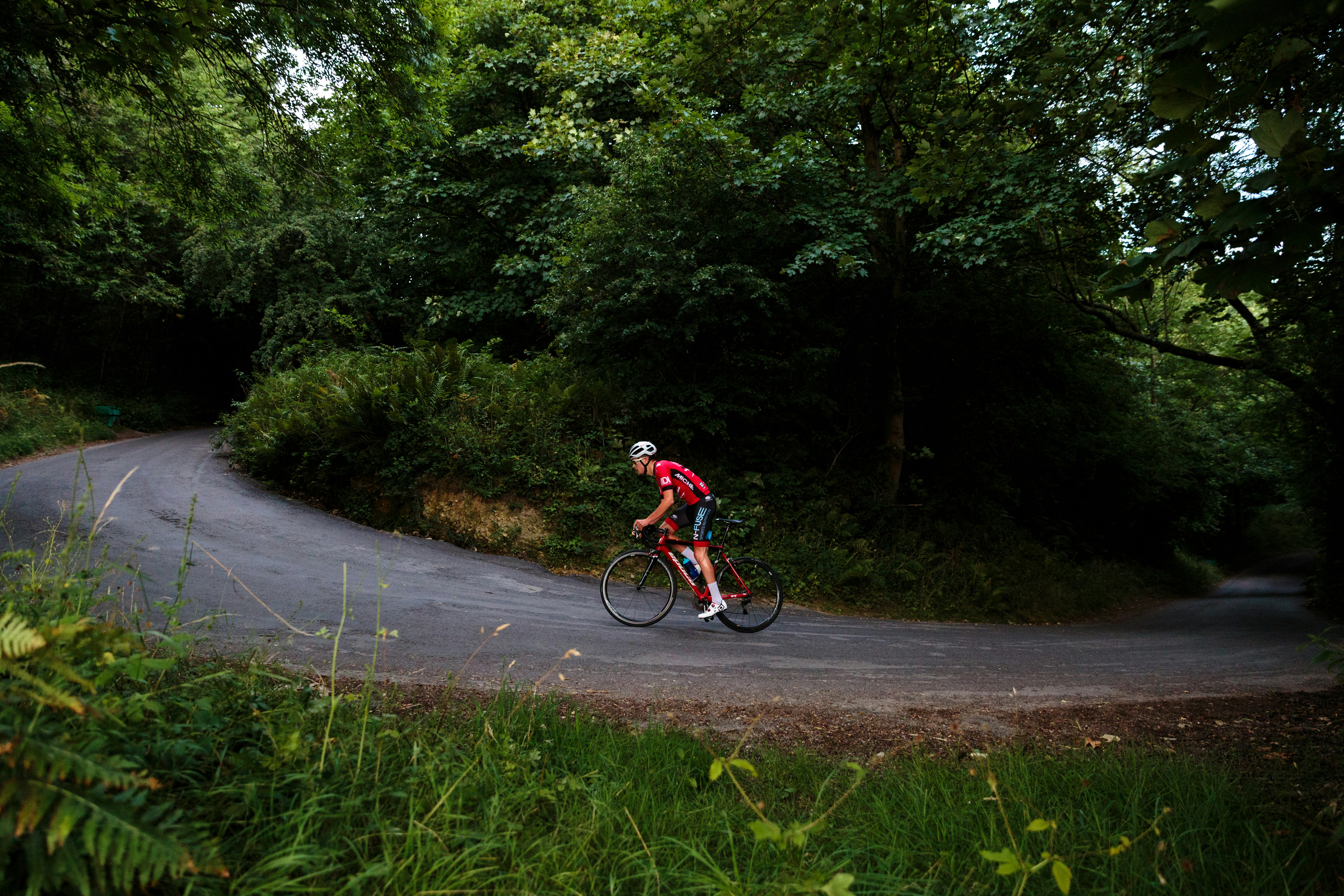 Cyclist riding a road bike outdoors in real conditions.