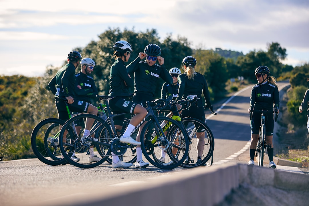 Group of road cyclists riding together outdoors on paved roads.