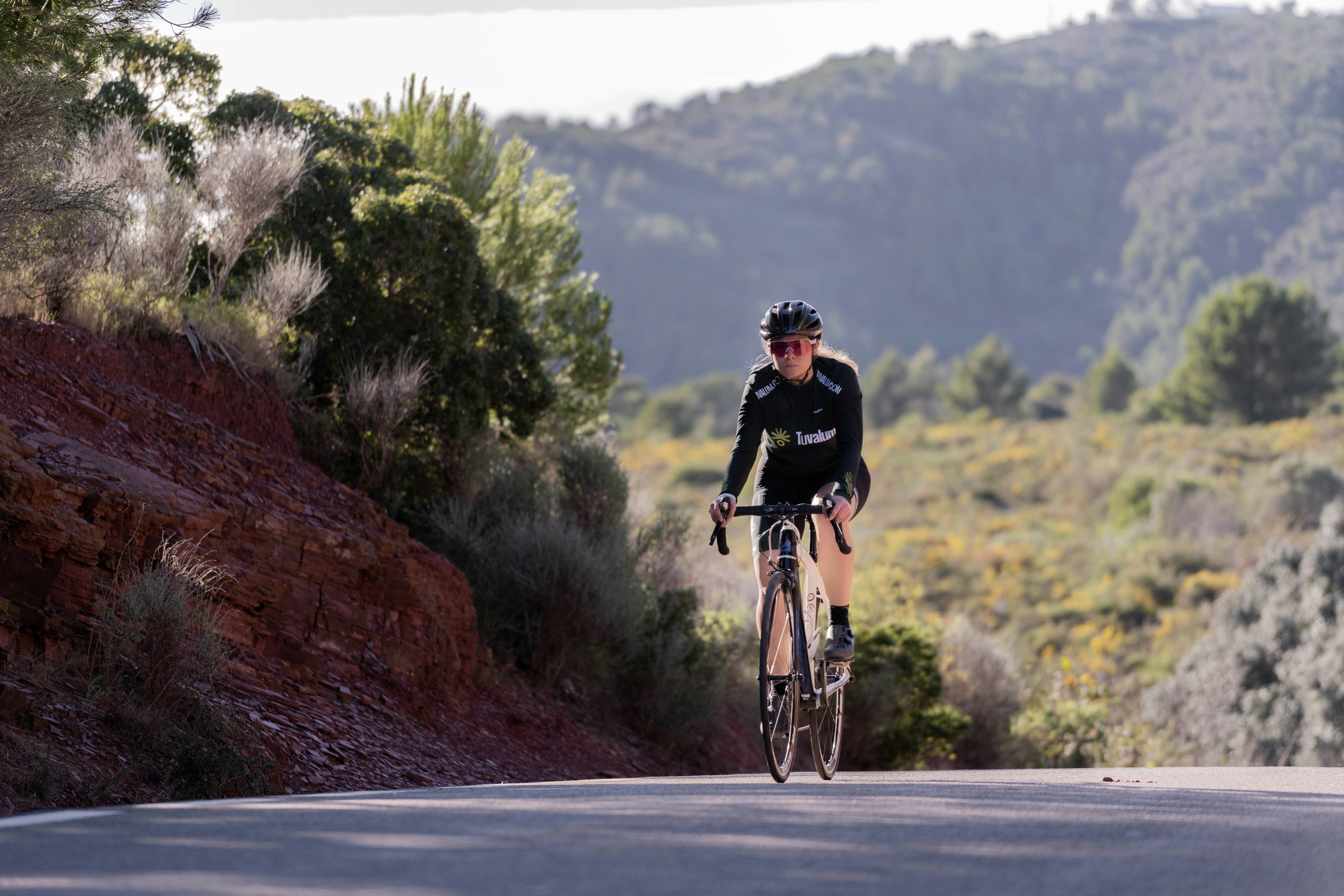 Cyclist riding a road bike outdoors in real conditions.