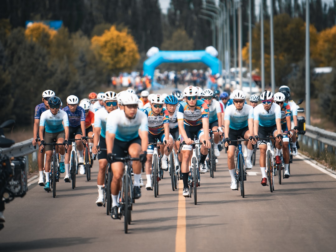 Group of road cyclists riding together outdoors on paved roads.