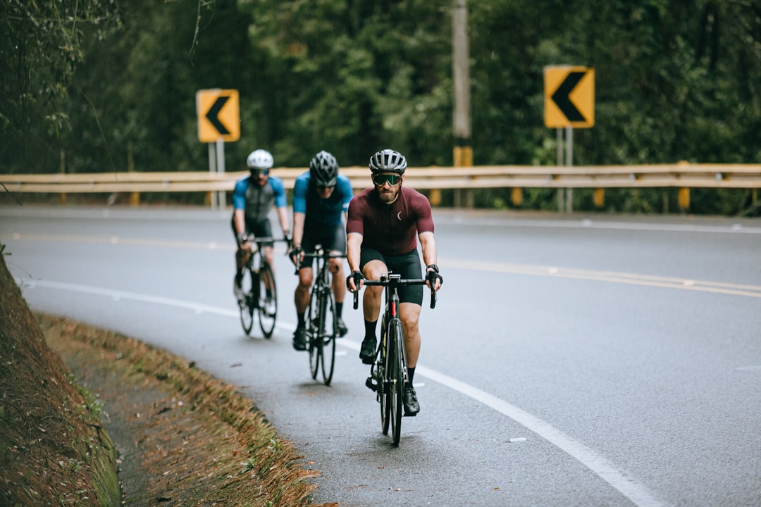 Group of road cyclists riding together outdoors on paved roads.