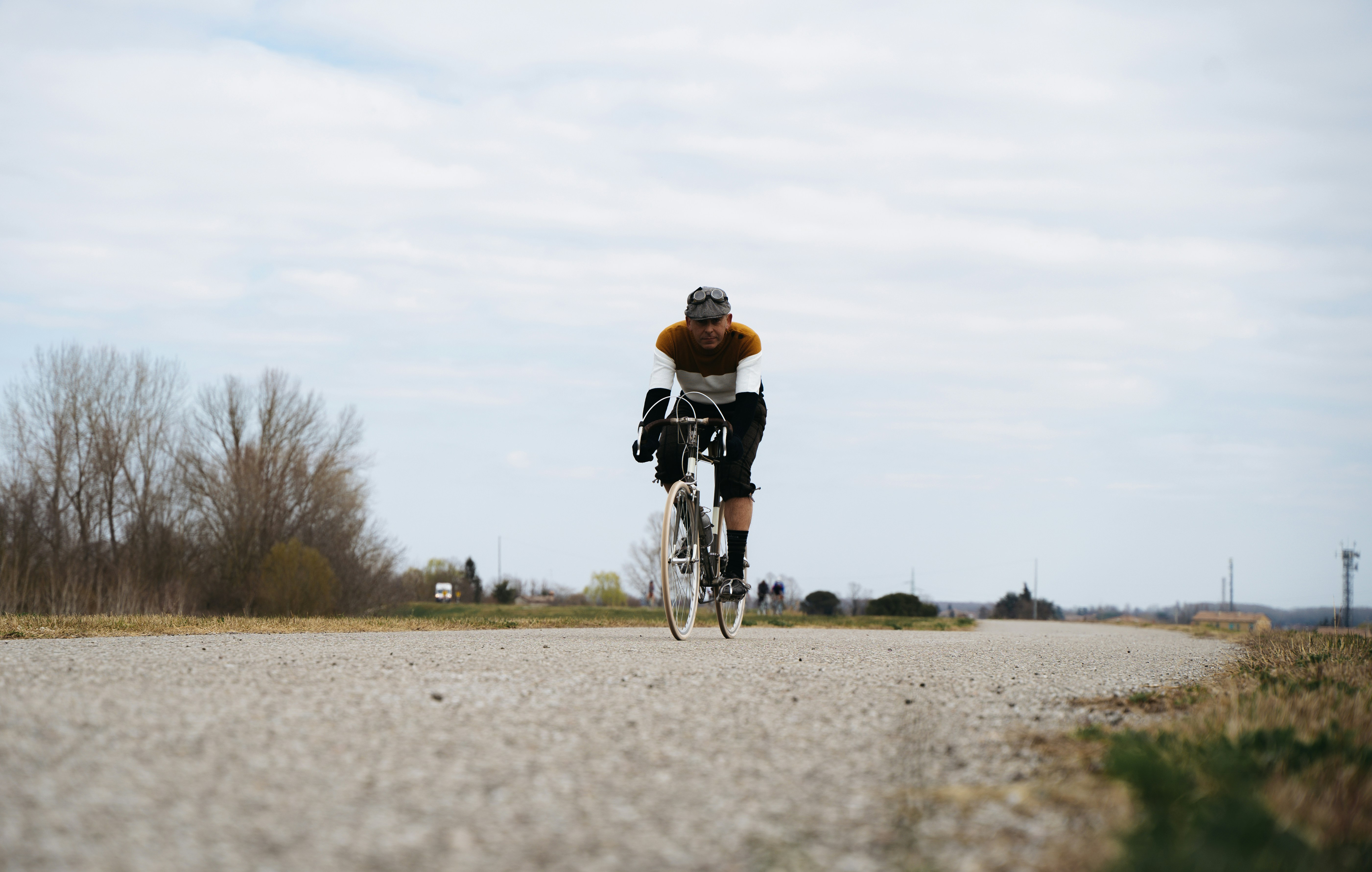Cyclist riding a road bike outdoors in real conditions.