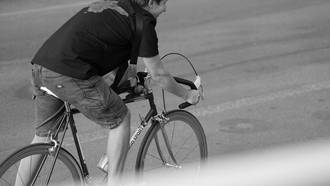 Group of road cyclists riding together outdoors on paved roads.