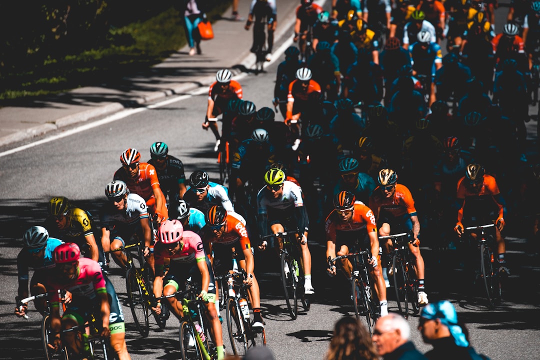 Group of road cyclists riding together outdoors on paved roads.