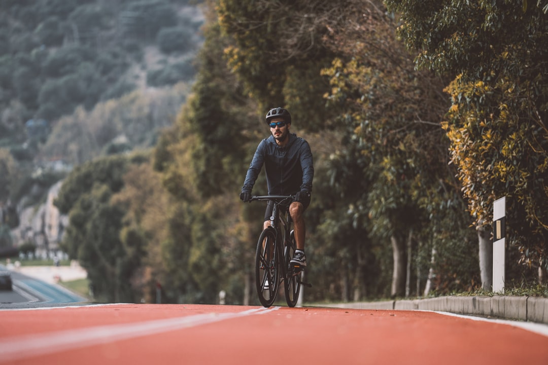 Group of road cyclists riding together outdoors on paved roads.