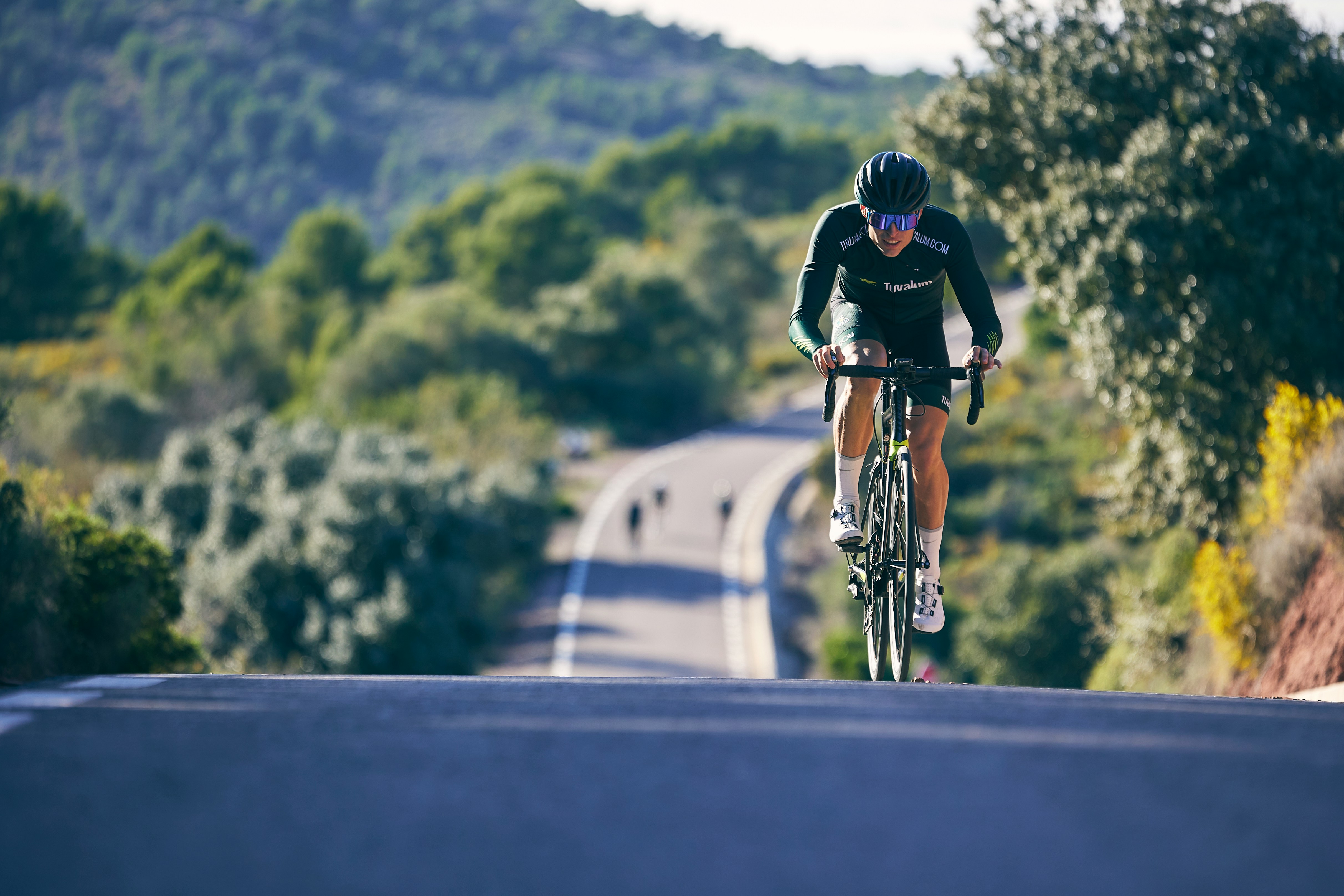 Cyclist riding a road bike outdoors in real conditions.