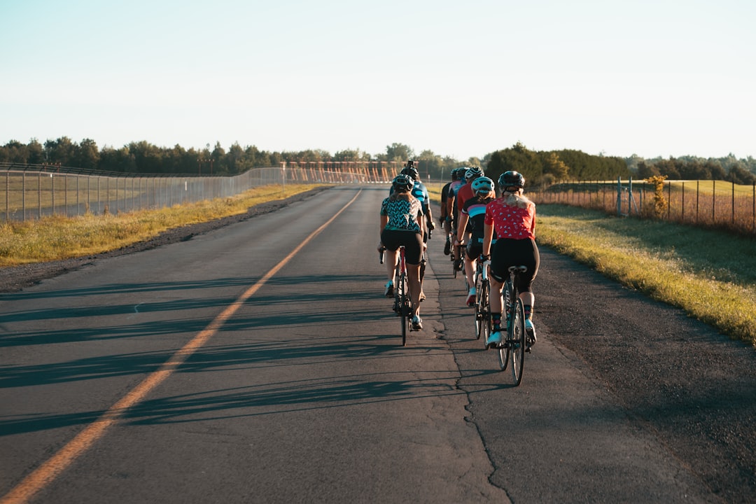 Group of road cyclists riding together outdoors on paved roads.