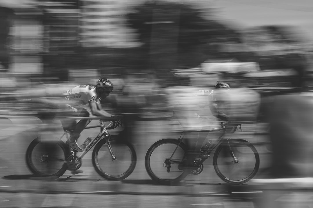 Group of road cyclists riding together outdoors on paved roads.