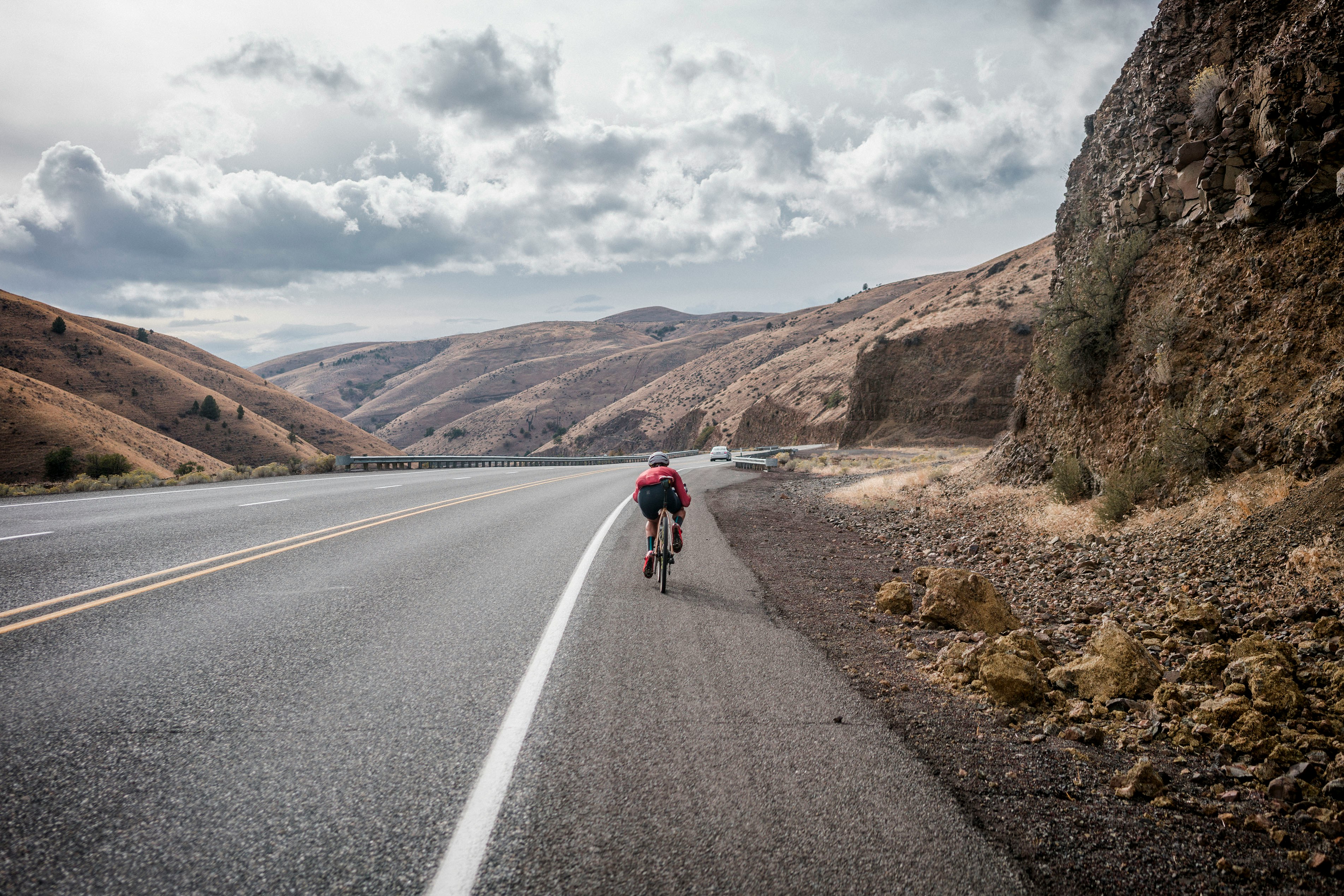 Cyclist riding a road bike outdoors in real conditions.