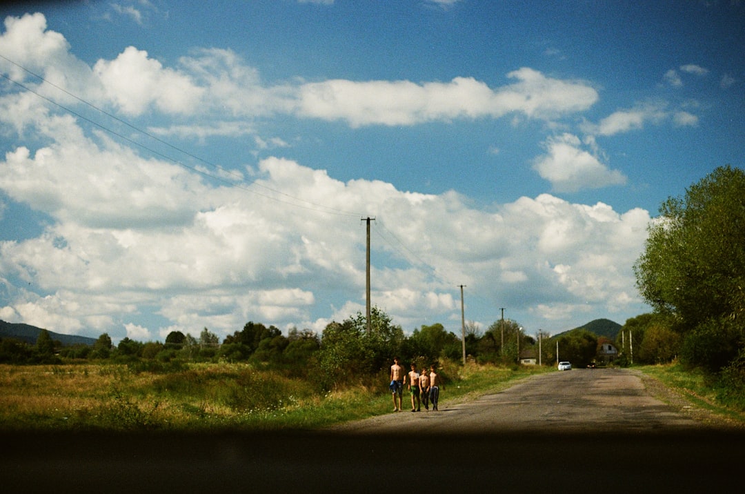 Group of road cyclists riding together outdoors on paved roads.