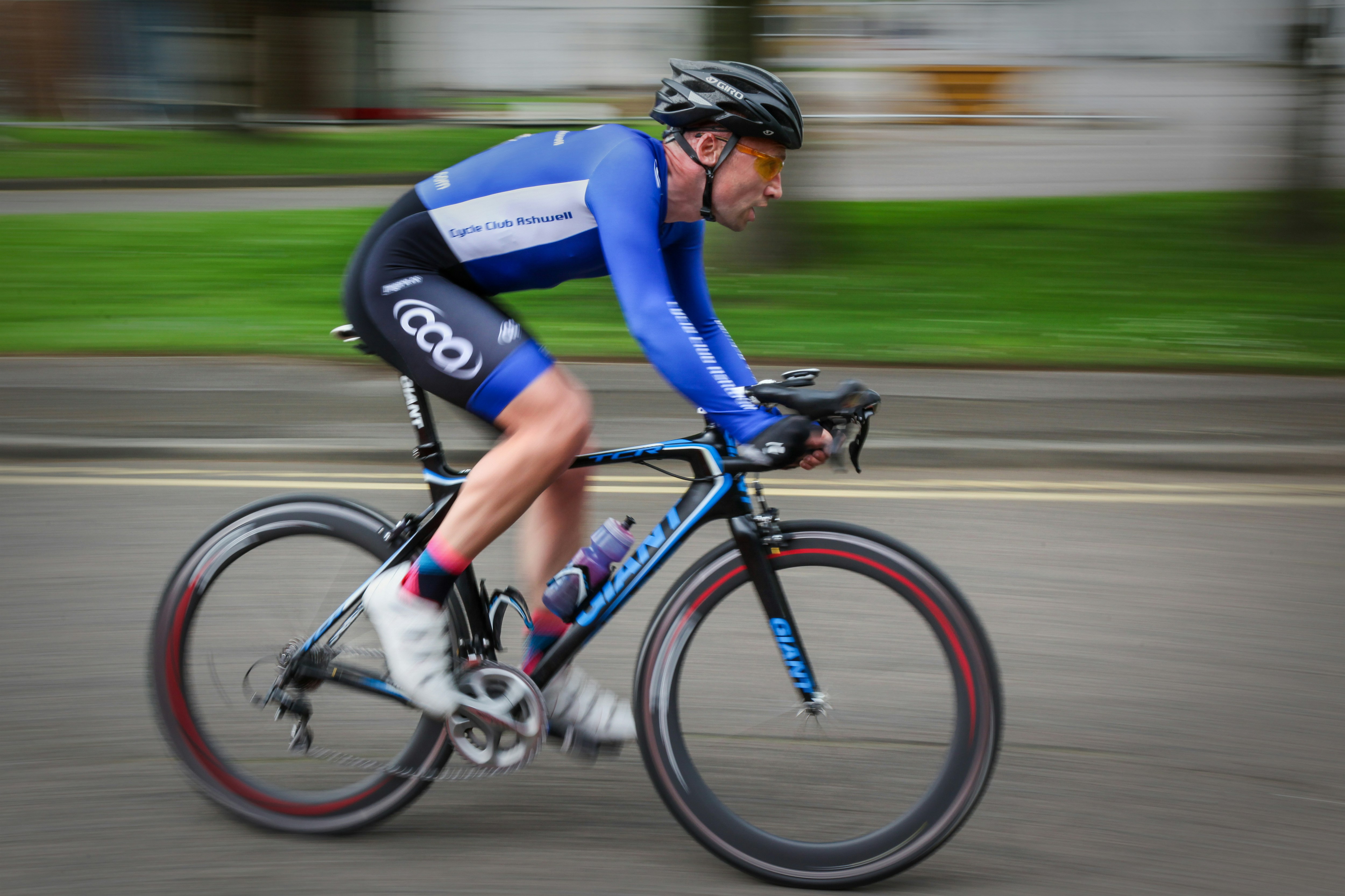 Cyclist riding a road bike outdoors in real conditions.