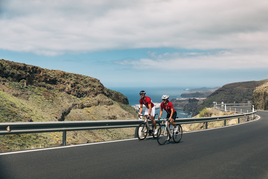 Group of road cyclists riding together outdoors on paved roads.