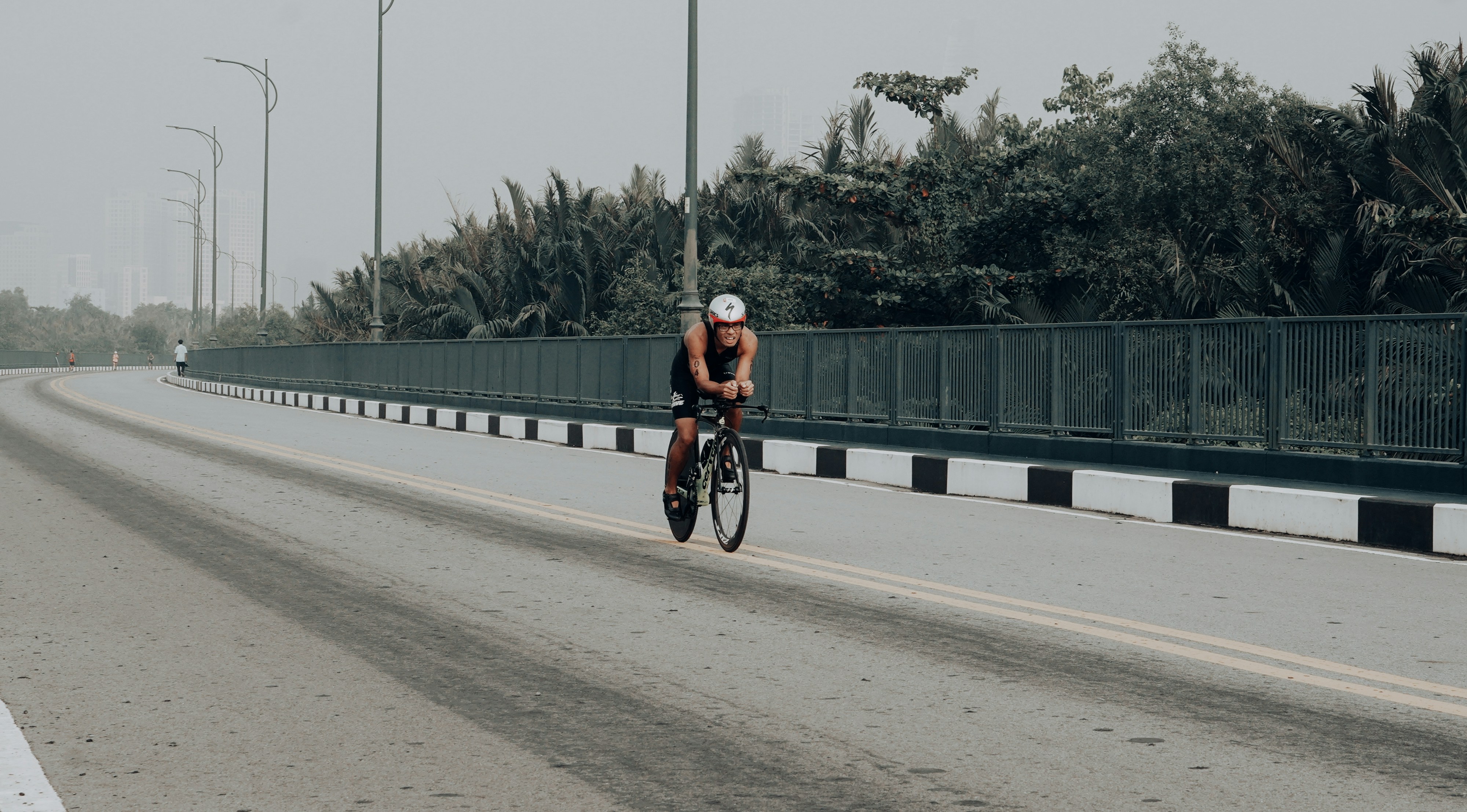 Cyclist riding a road bike outdoors in real conditions.