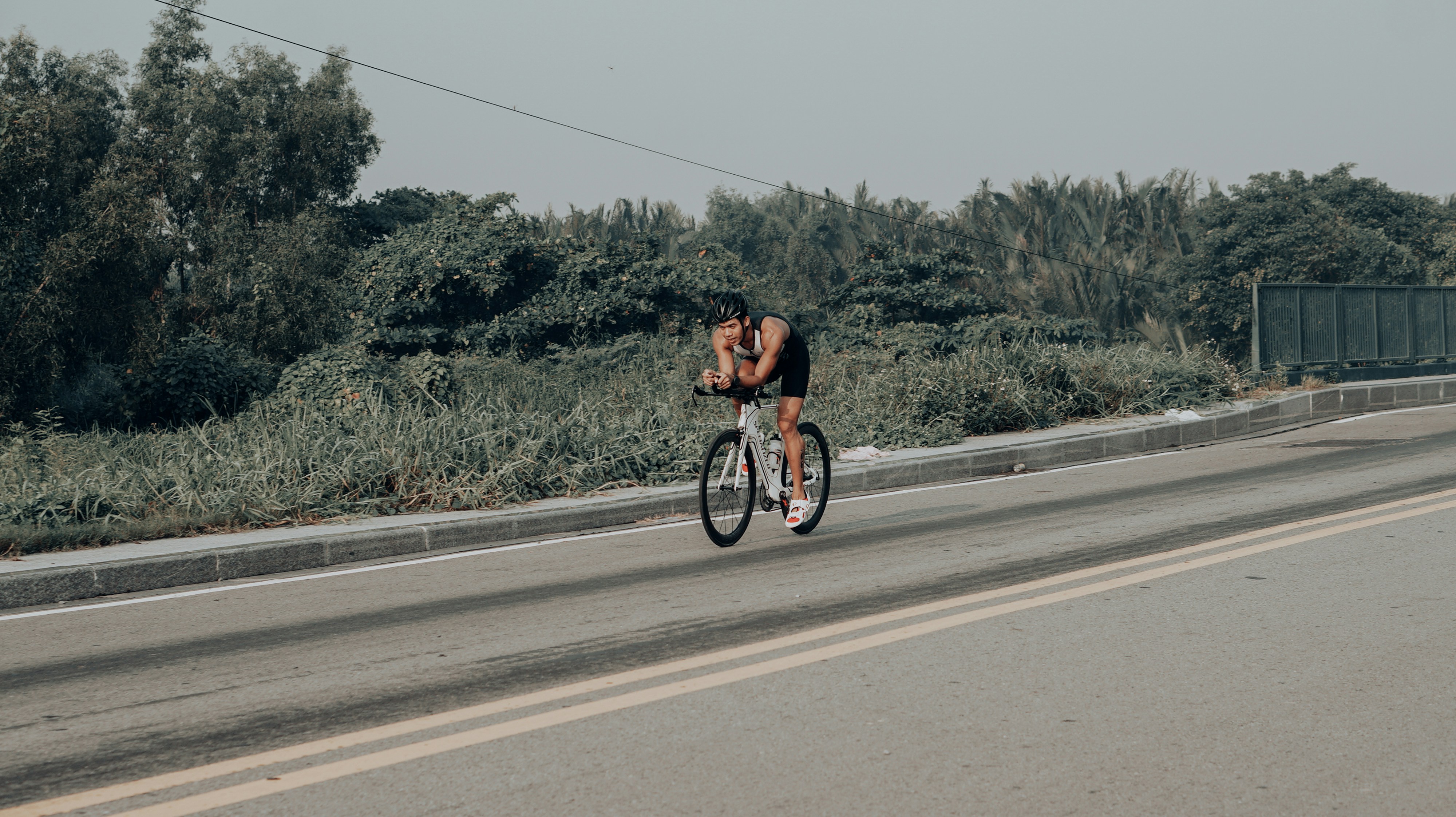Cyclist riding a road bike outdoors in real conditions.