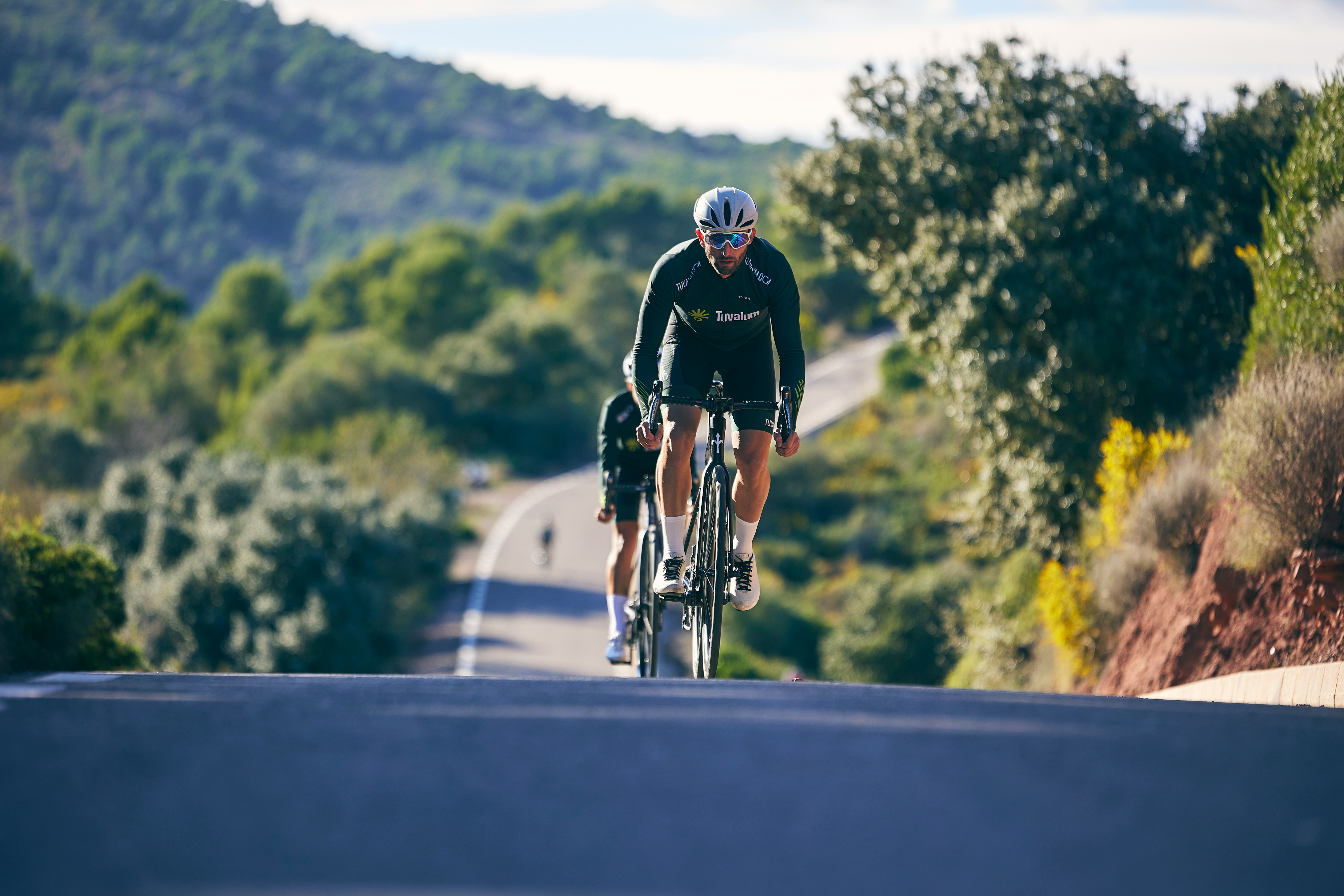 Cyclist riding a road bike outdoors in real conditions.