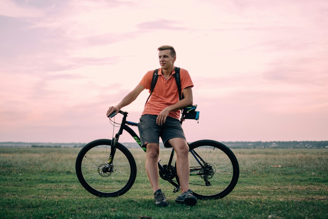 Close-up of a cyclist pedaling on a road bike with a power meter visible.