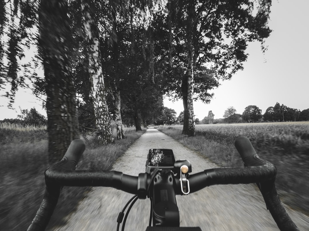 Close-up of a cyclist pedaling on a road bike with a power meter visible.