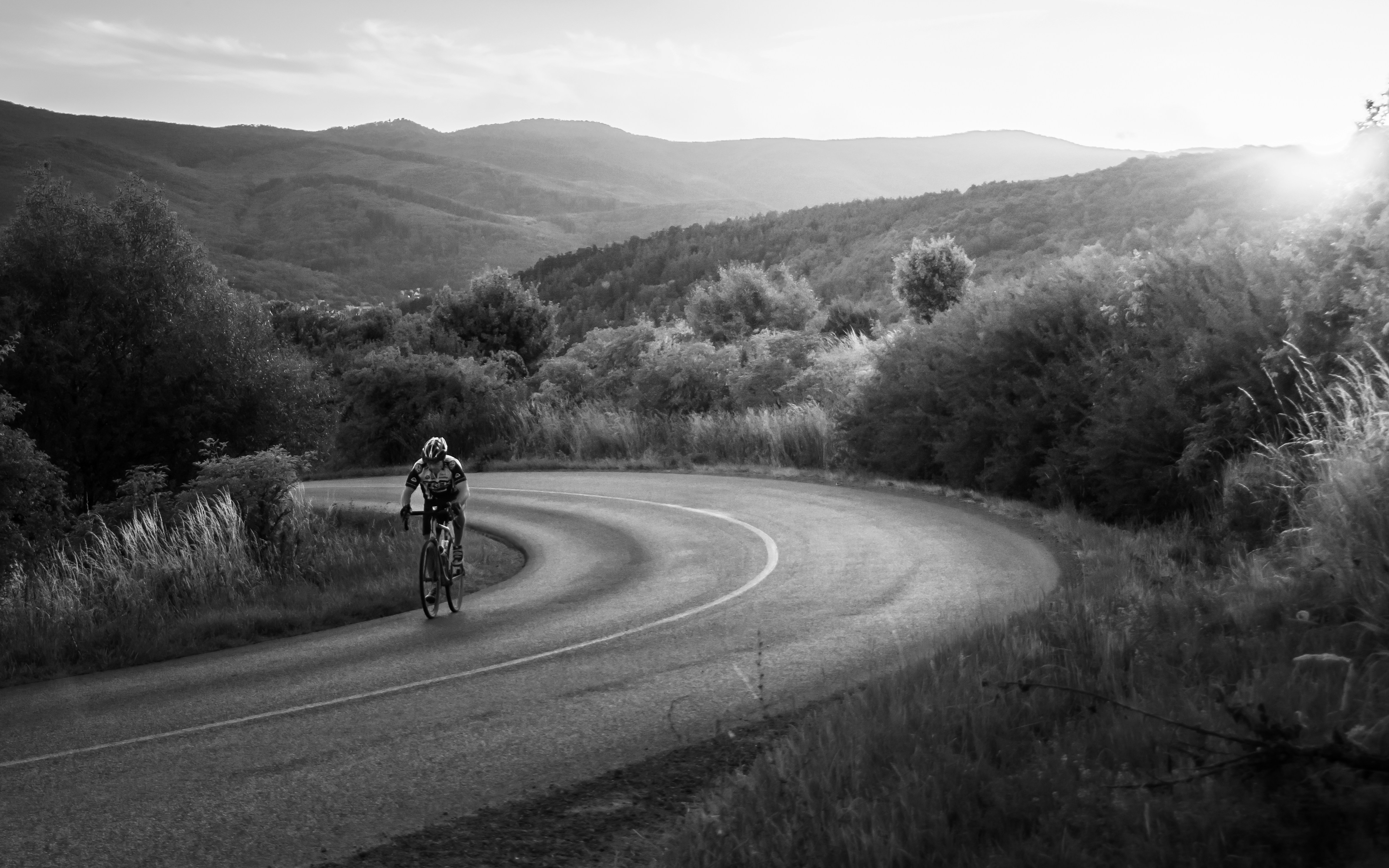 Cyclist riding a road bike outdoors in real conditions.