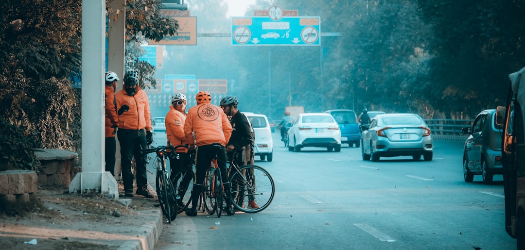 Group of road cyclists riding together outdoors on paved roads.