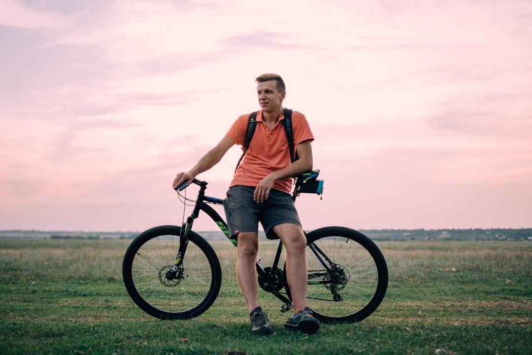 Close-up of a cyclist pedaling on a road bike with a power meter visible.