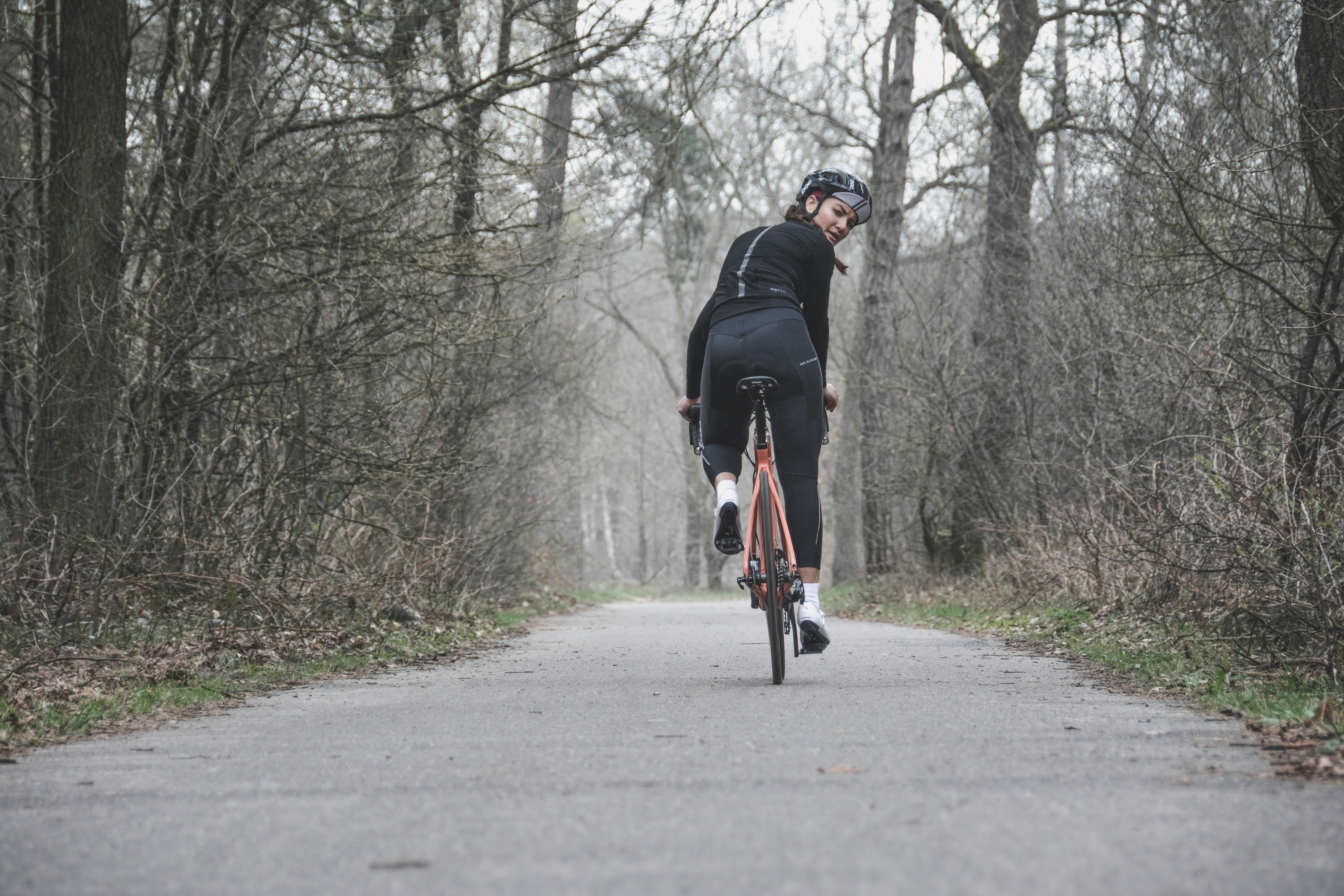 Cyclist riding a road bike outdoors in real conditions.
