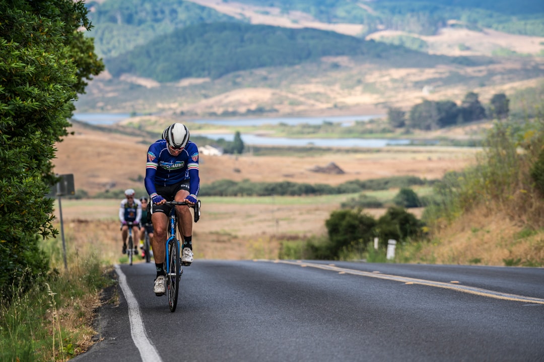 Group of road cyclists riding together outdoors on paved roads.