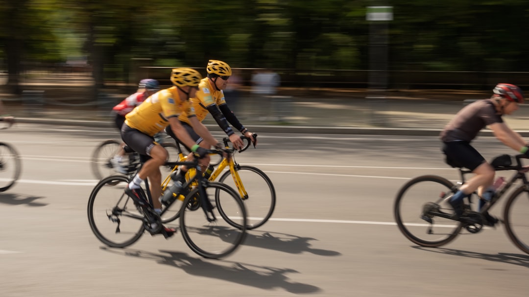 Close-up of a cyclist pedaling on a road bike with a power meter visible.