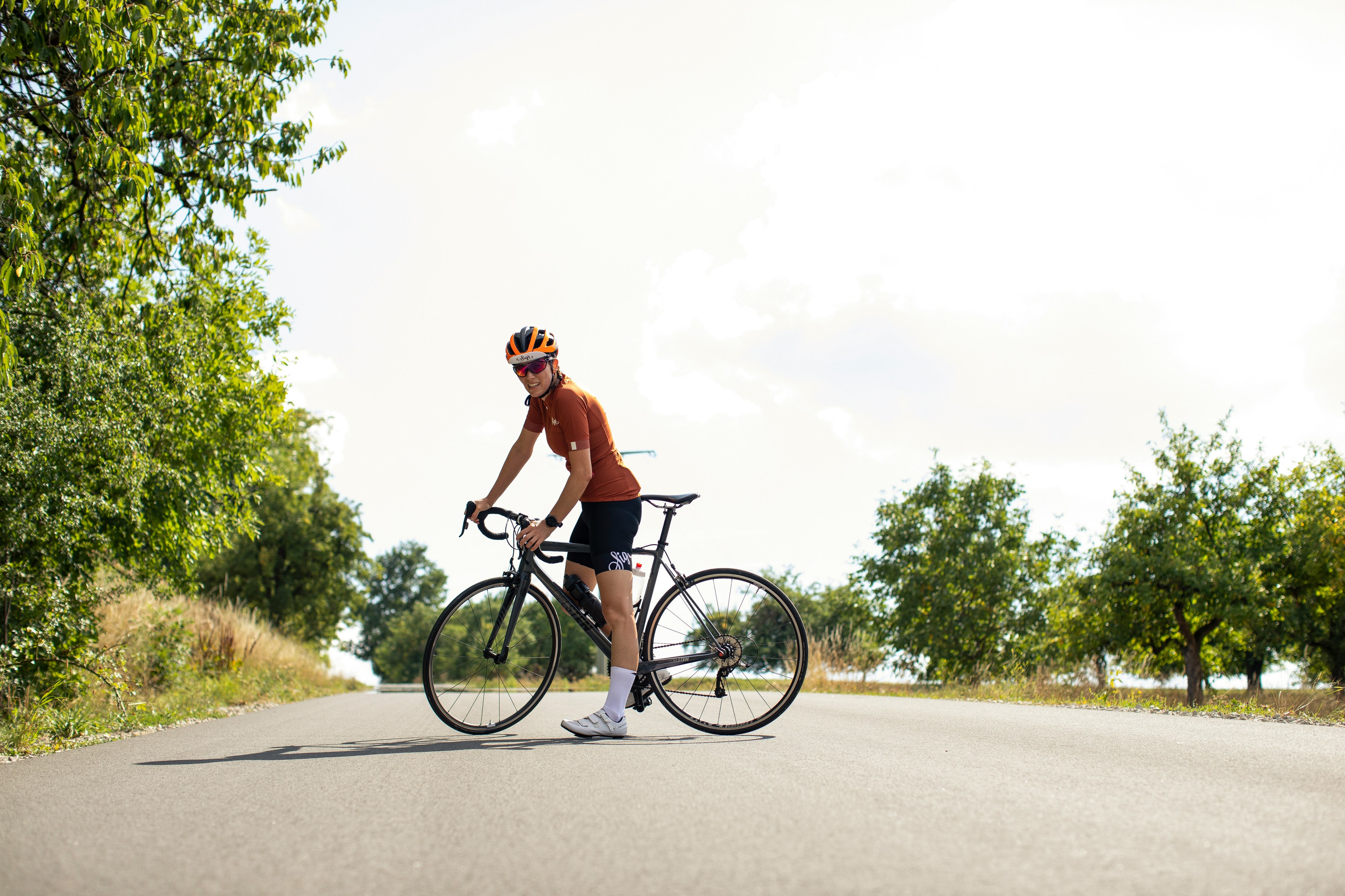 Cyclist riding a road bike outdoors in real conditions.