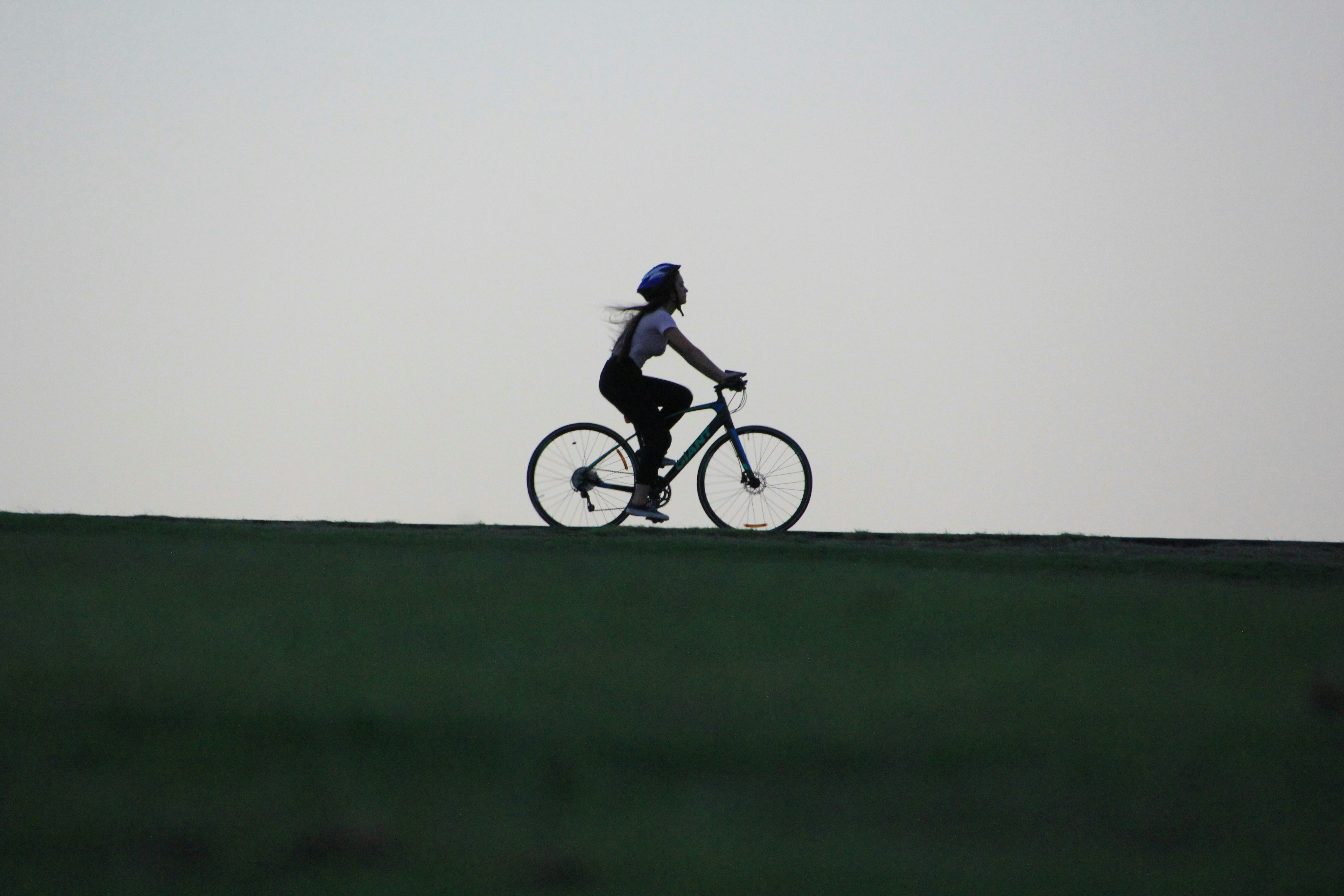 Cyclist riding a road bike outdoors in real conditions.