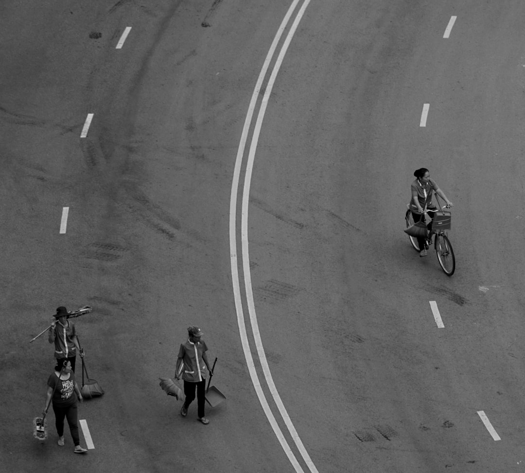 Group of road cyclists riding together outdoors on paved roads.