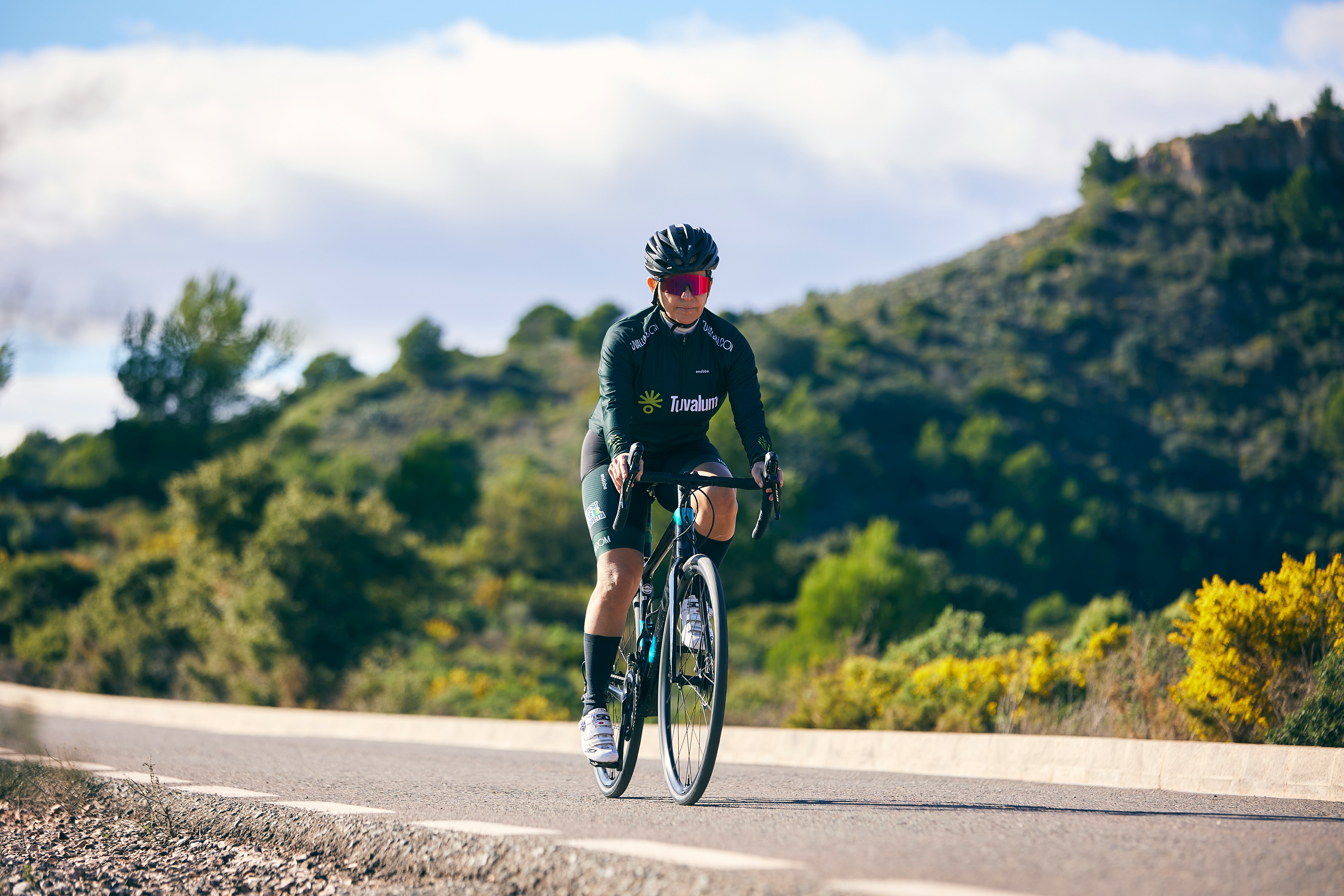 Cyclist riding a road bike outdoors in real conditions.