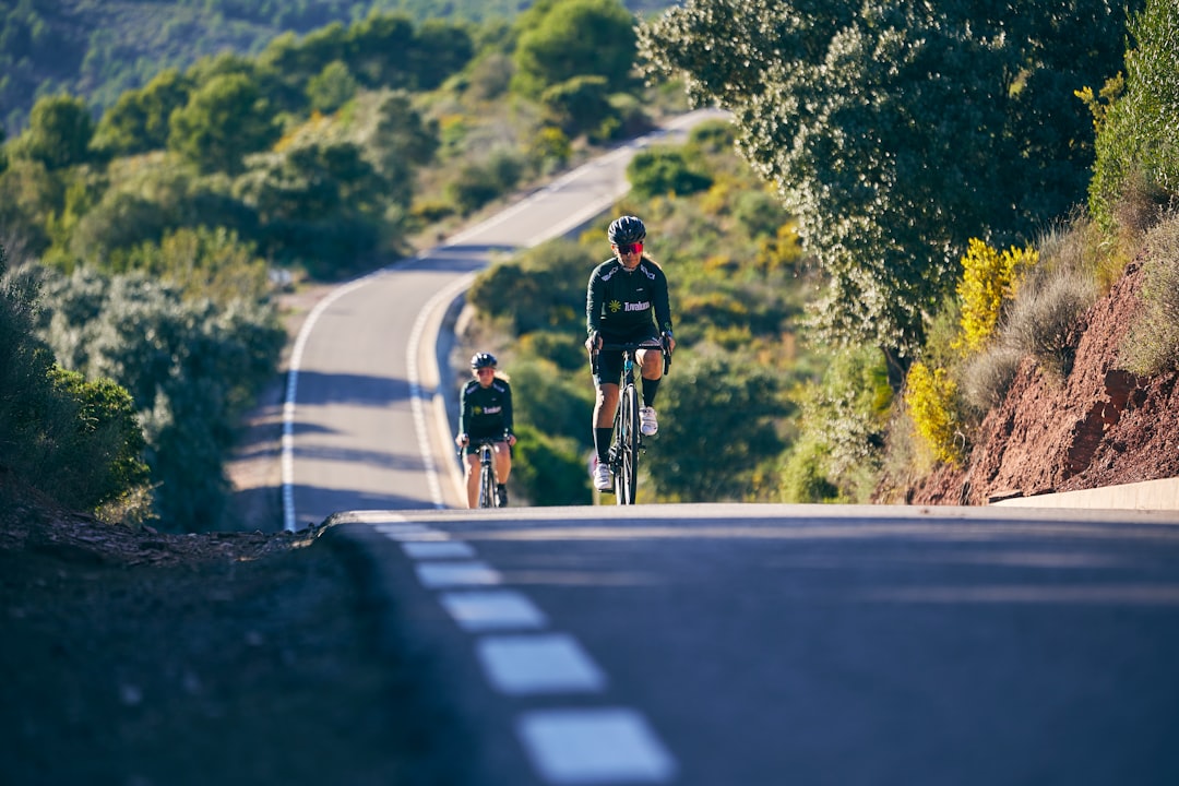 Group of road cyclists riding together outdoors on paved roads.