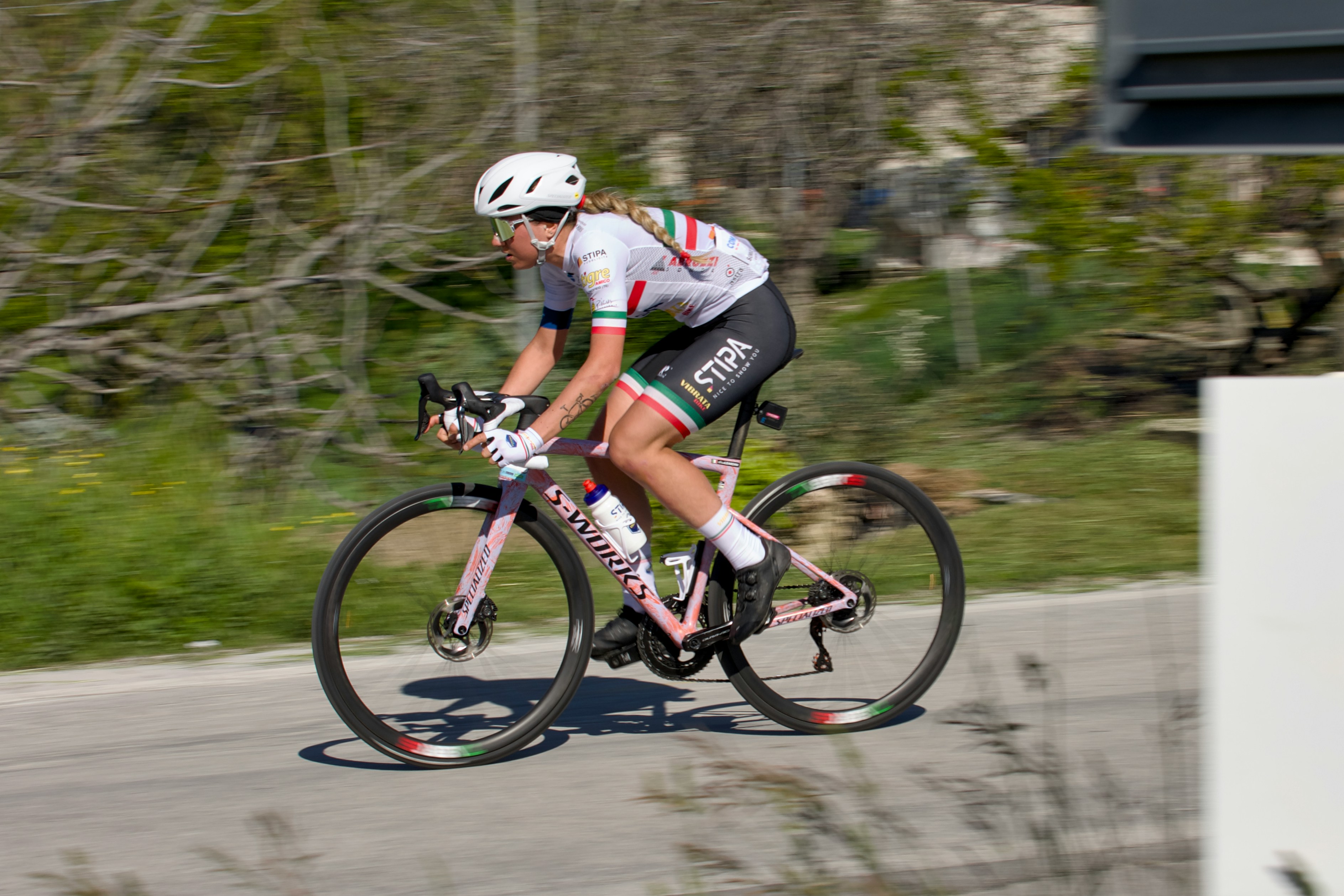 Cyclist riding a road bike outdoors in real conditions.